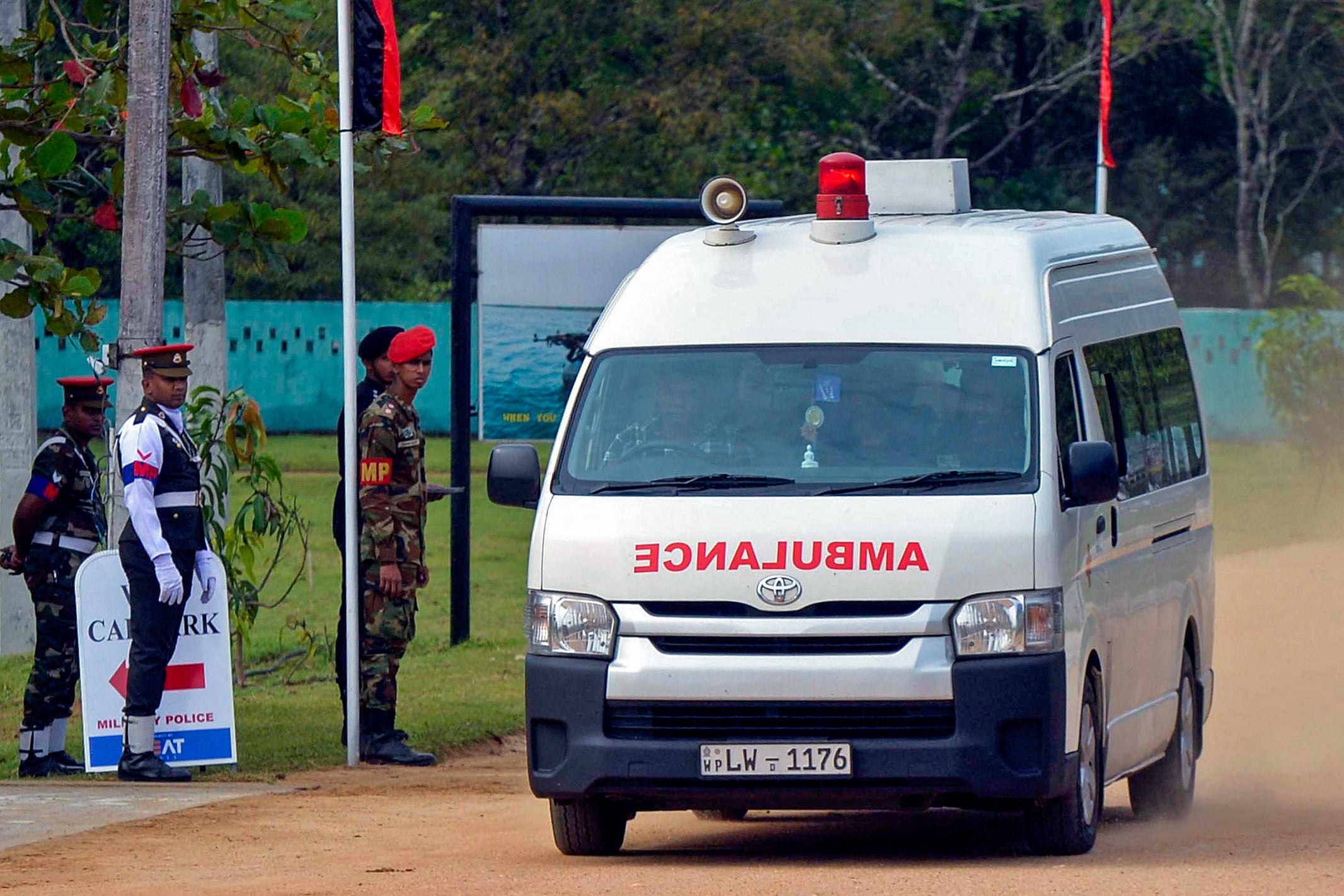 An ambulance transports victims of a fatal helicopter crash, in Maduru Oya, east of capital Colombo on May 9, 2025.