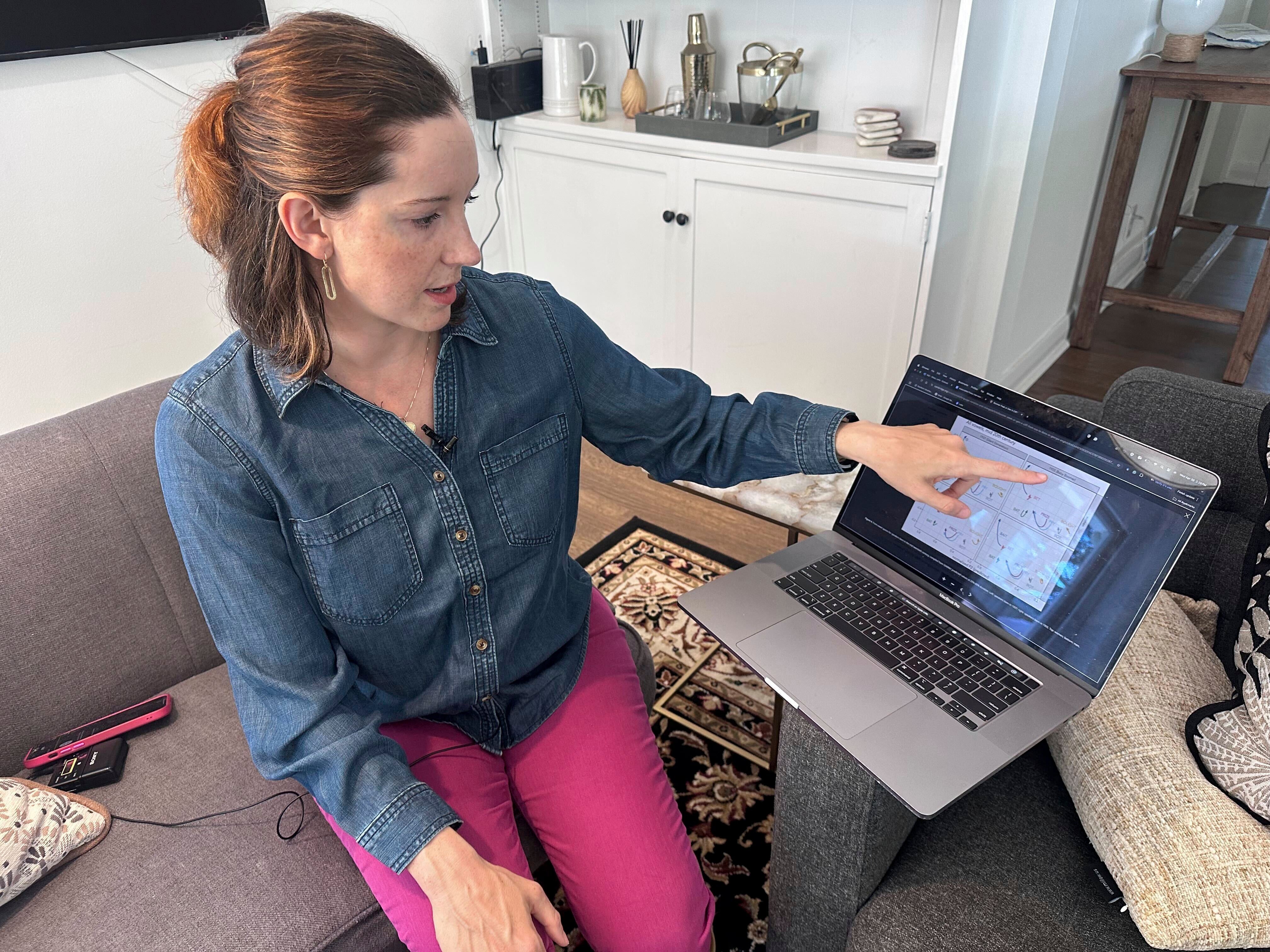 Georgia Tech linguist Lelia Glass points to a diagram showing how the pronunciation of certain words by metro-Atlanta residents has changed over several generations at her home in Atlanta, on Wednesday, April 30, 2025. (AP Photo/Sharon Johnson)