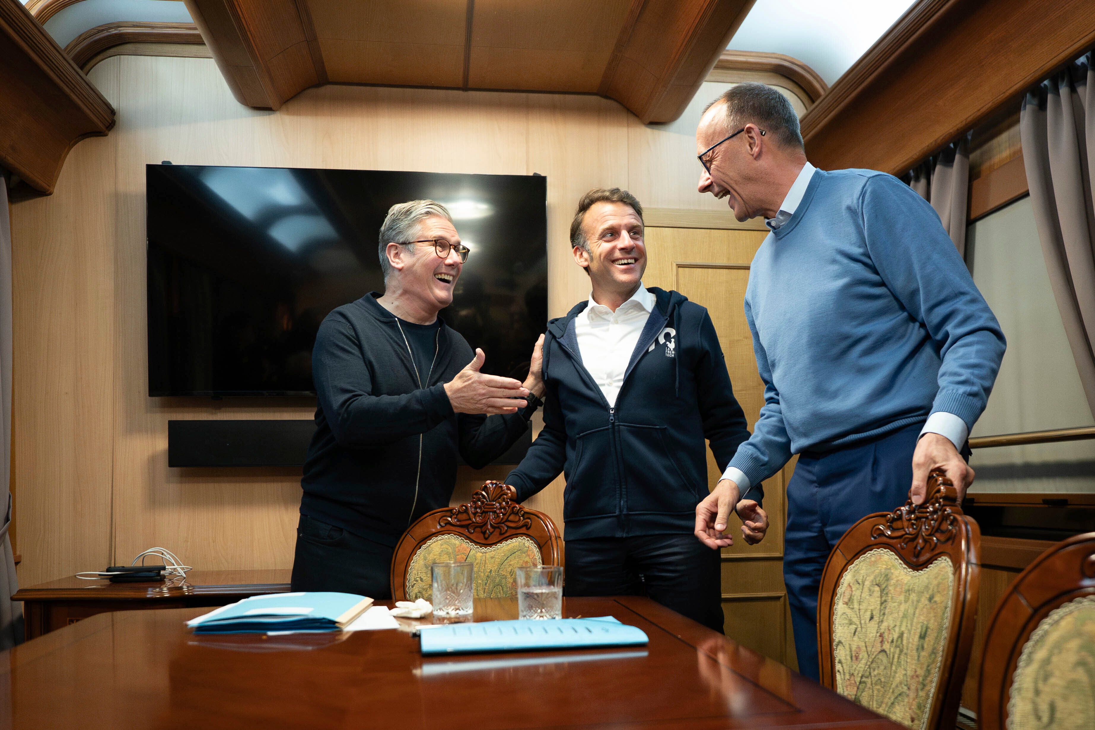 Britain's Prime Minister Keir Starmer, left, meets with French President Emanuel Macron, center, and German Chancellor Friedrich Merz onboard a train to the Ukrainian capital Kyiv where all three will hold meetings with Ukrainian President Volodymyr Zelenskyy
