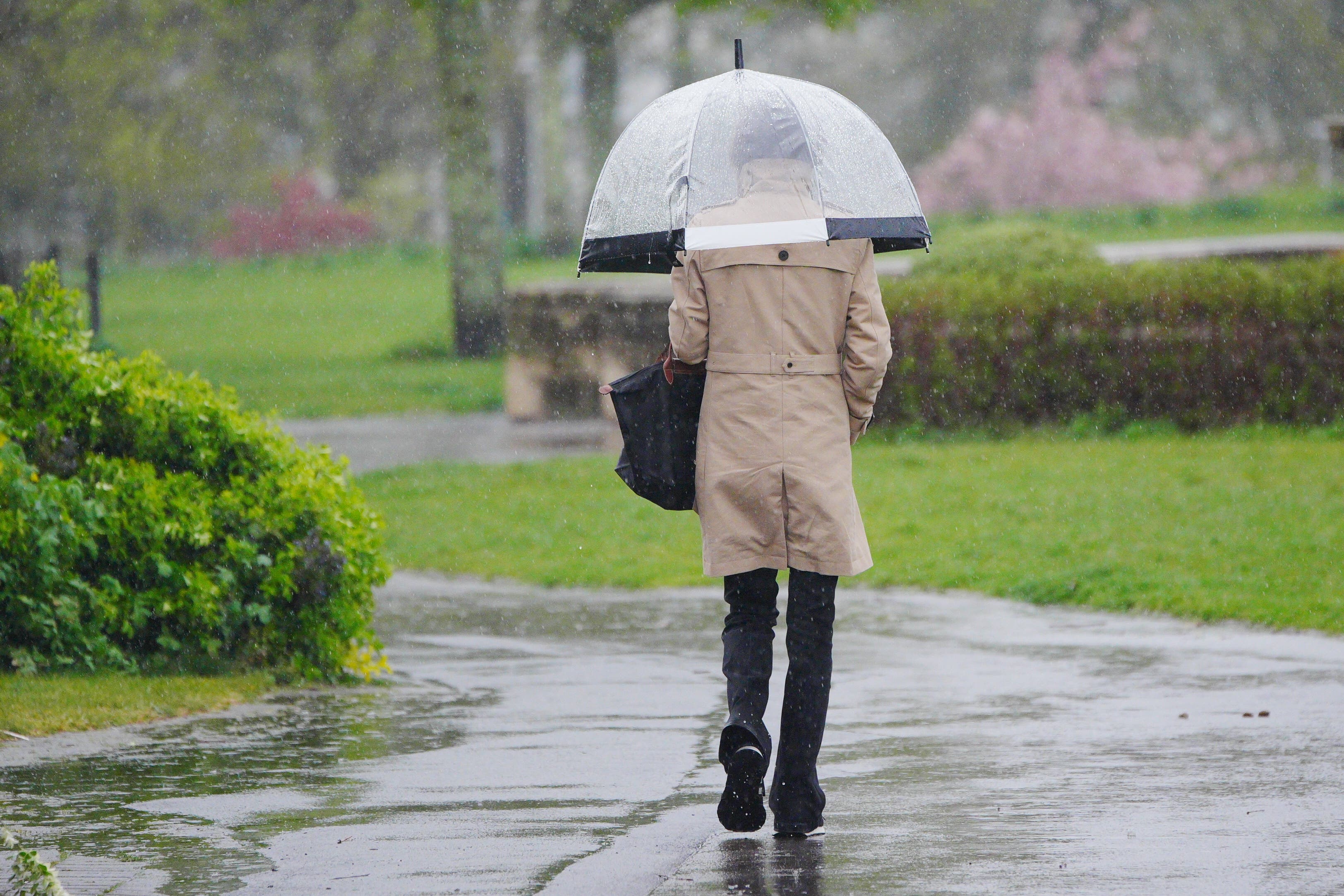 People walking in the heavy rain (Ben Birchall/PA)