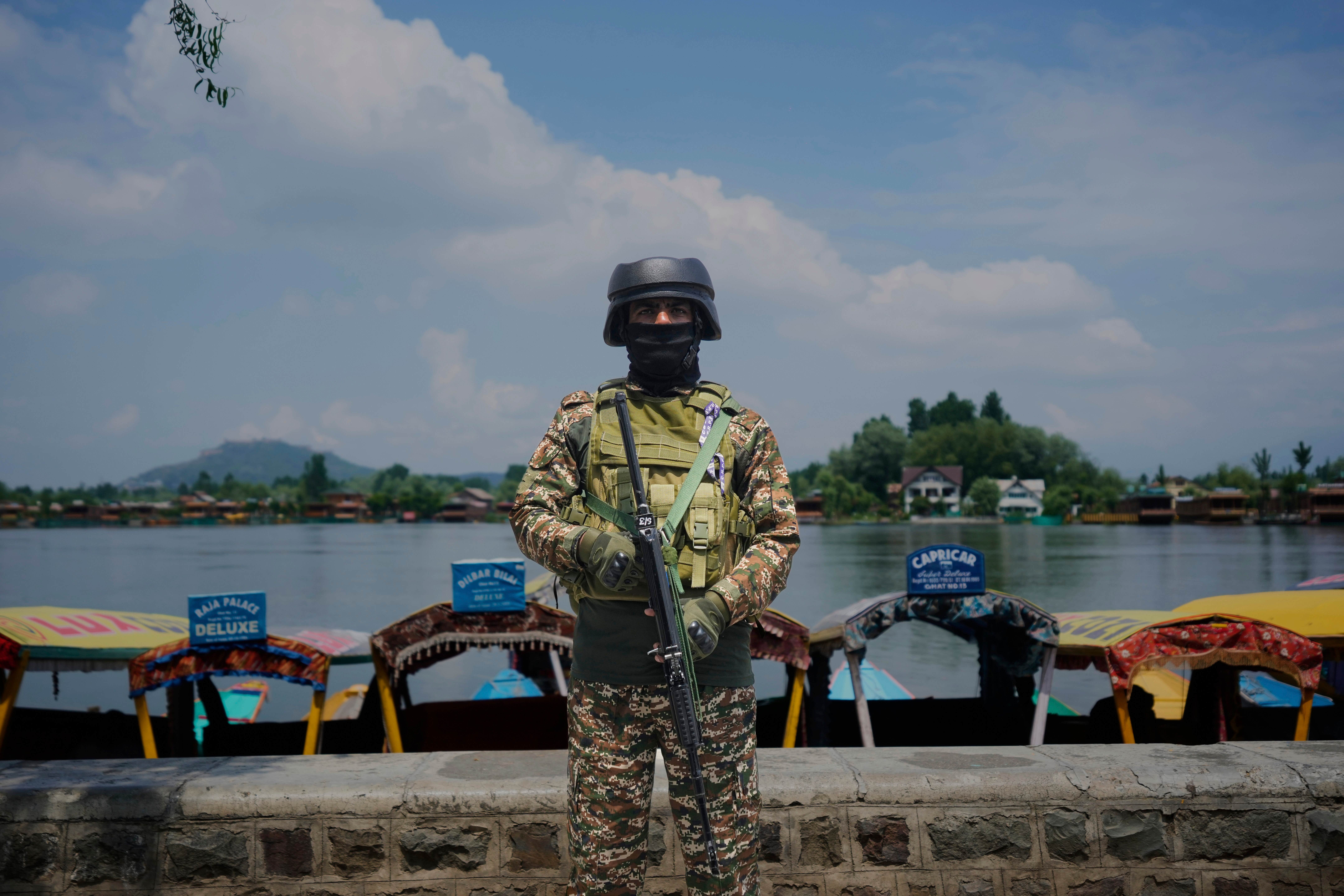 An Indian paramilitary soldier stands guard on the banks of Dal Lake (AP Photo/Mukhtar Khan)