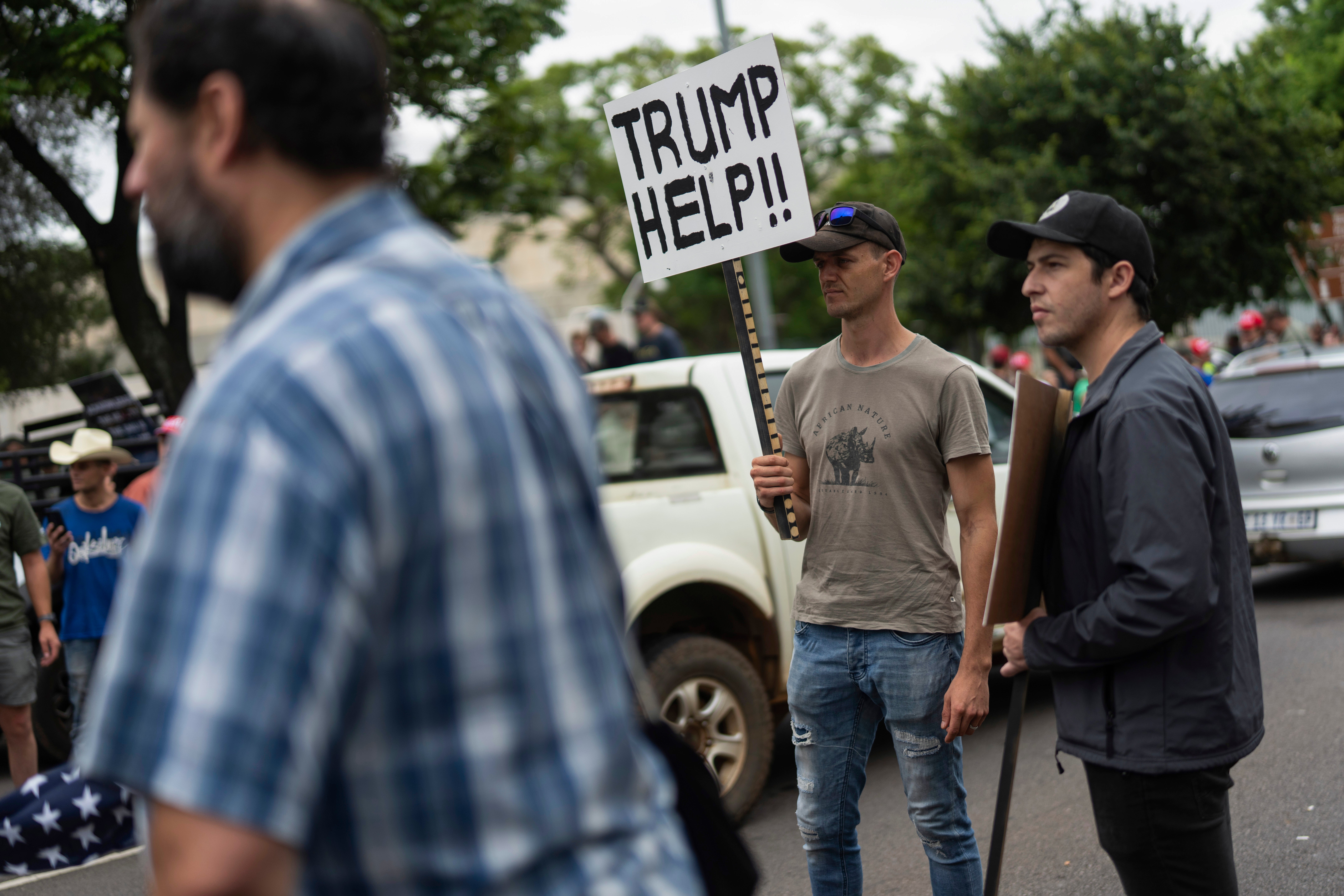 White South Africans demonstrate in support of U.S. President Donald Trump in front of the U.S. embassy in Pretoria, South Africa, Saturday, Feb. 15, 2025. (AP Photo/Jerome Delay, File)