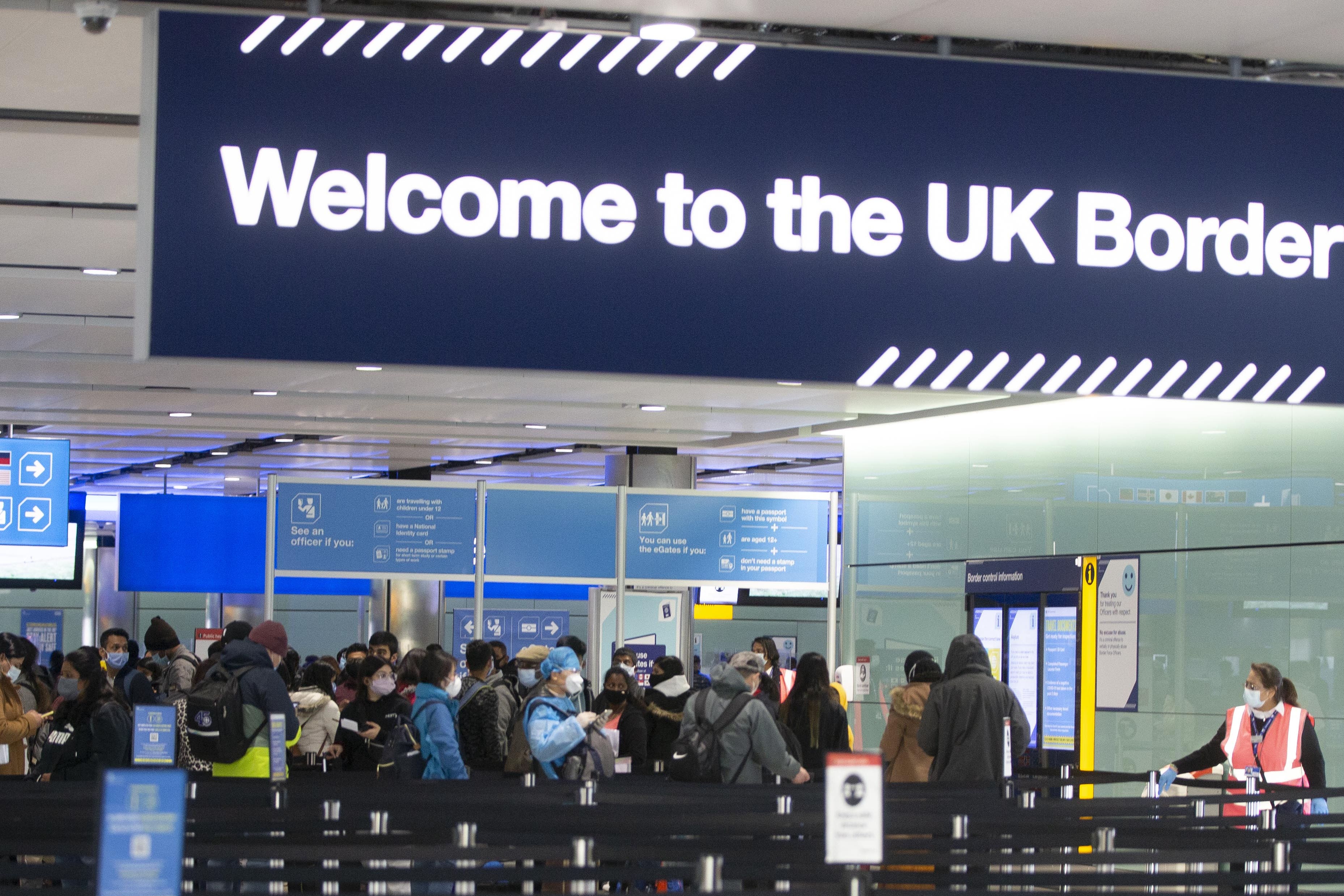 Passengers line up for passport control at Heathrow Airport (PA)