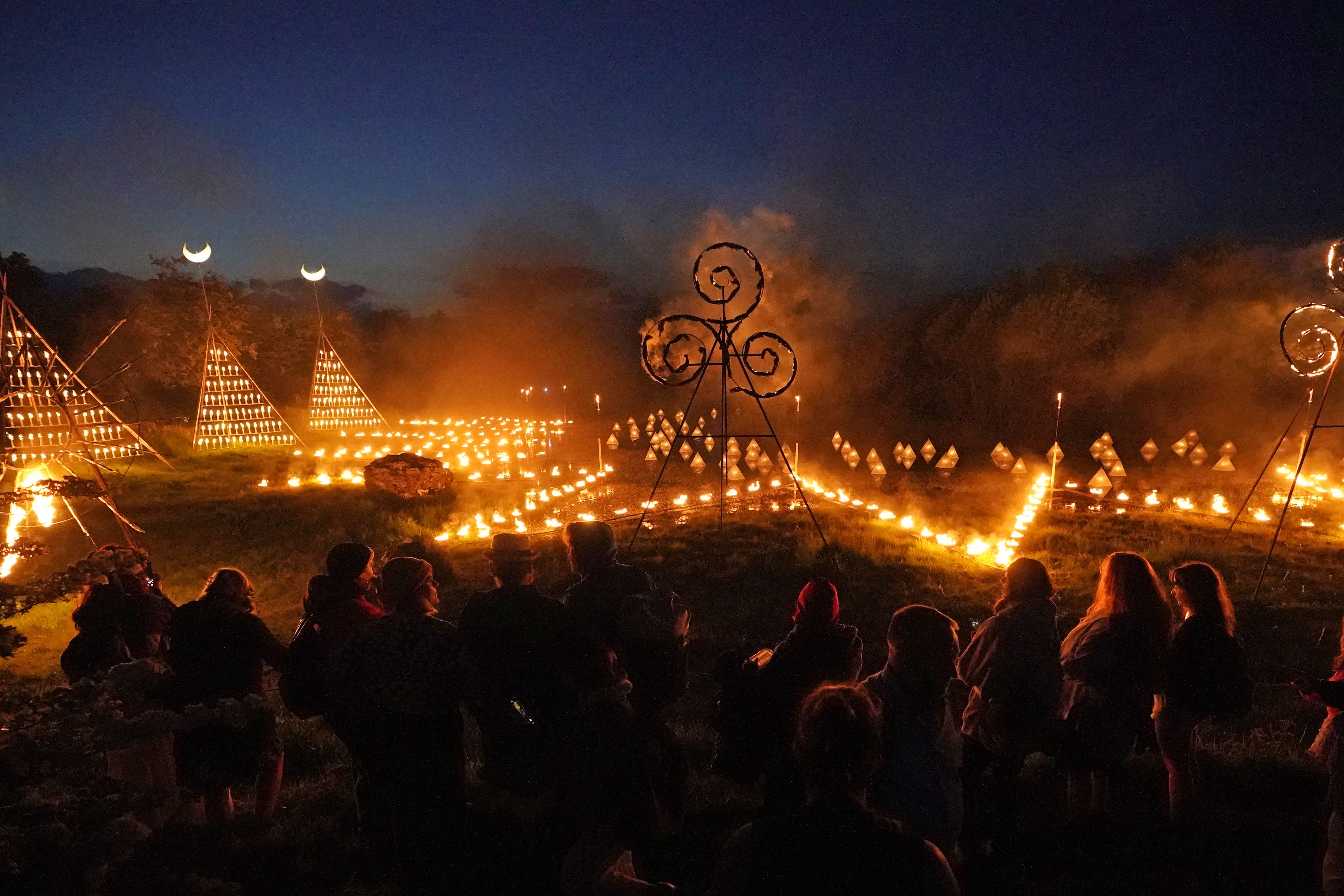 Crowds watch illuminations during the Bealtaine Fire Festival at the Hill of Uisneach in Co Westmeath (Niall Carson/PA)