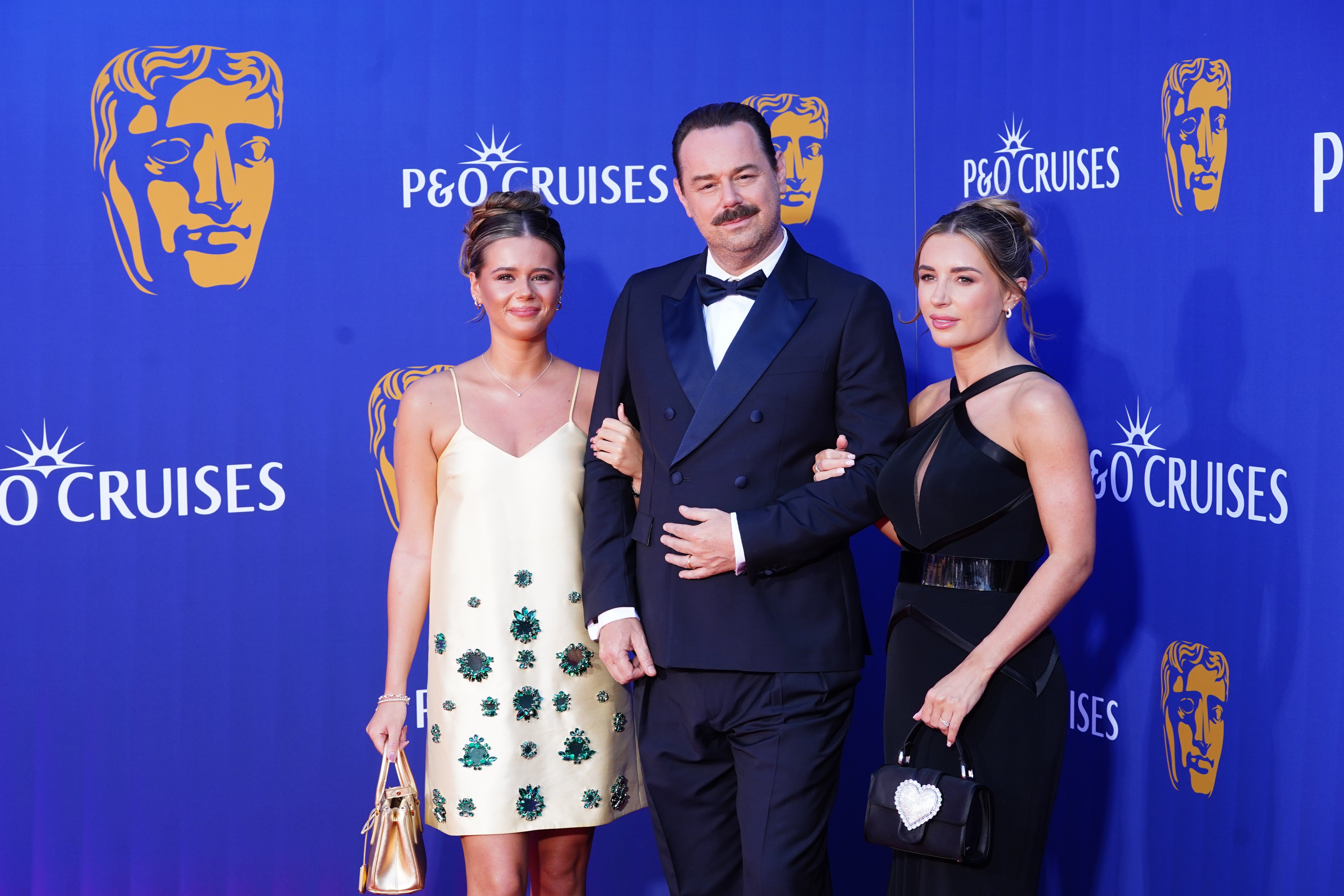 The actor was joined by his daughters Sunnie Jo Dyer (left) and Dani Dyer (right) (Ian West/PA)