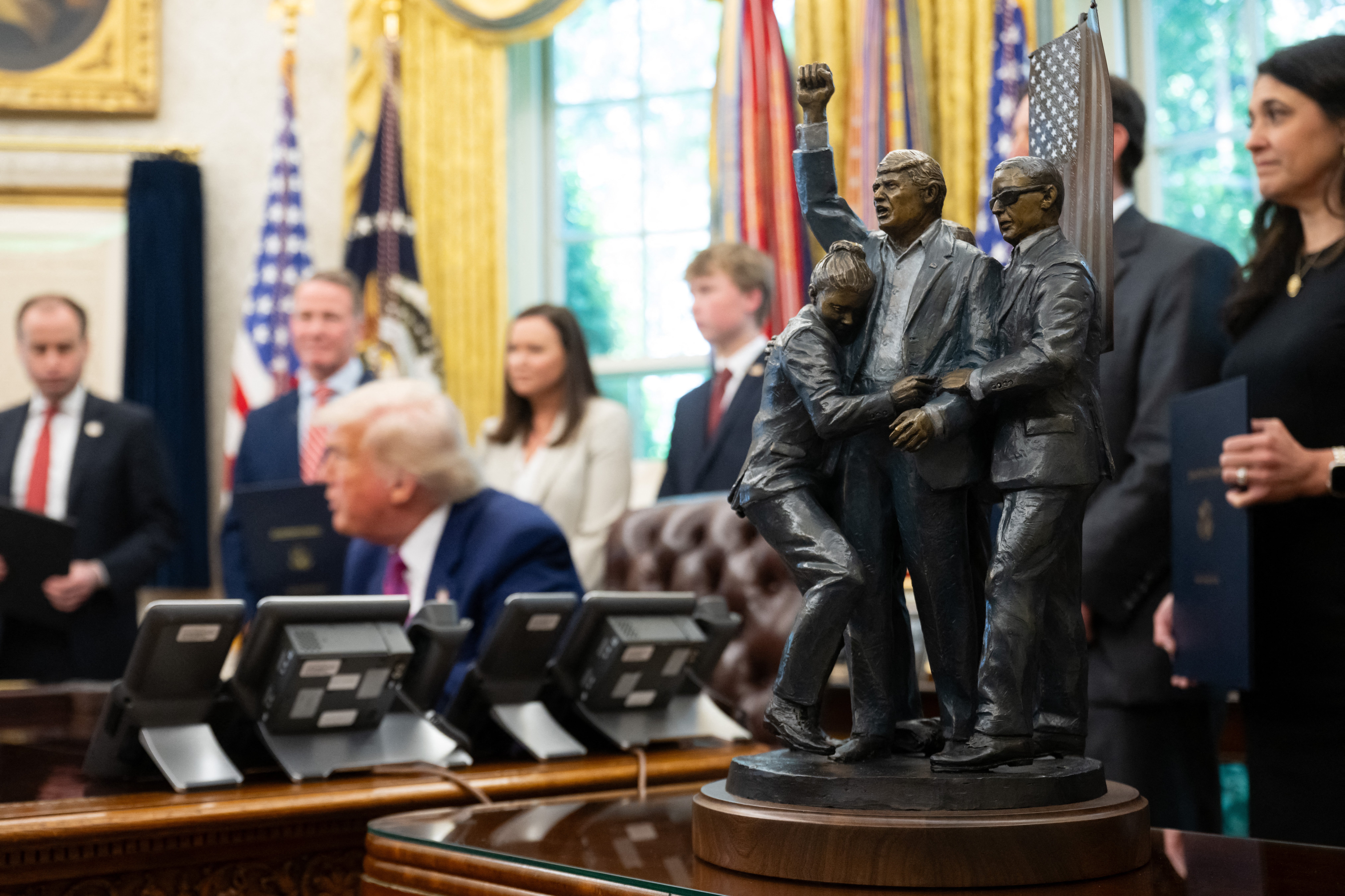 Trump adds a new piece of art to the Oval Office - a statue of himself moments after the assassination attempt in Butler