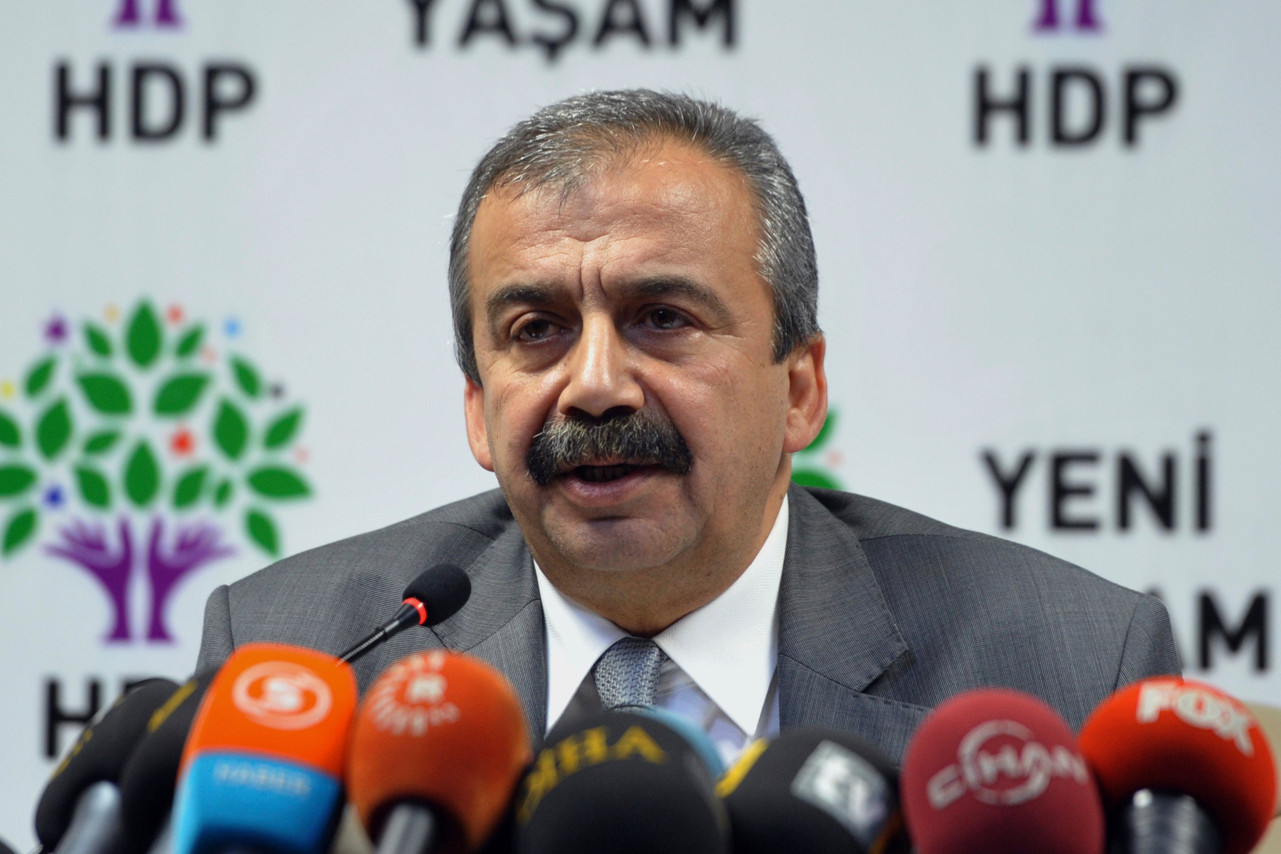 Lawmaker of the pro-Kurdish Peoples' Democracy Party Sirri Sureyya Onder speaks to the media after talks with Prime Minister Ahmet Davutoglu in Ankara, Turkey, Wednesday, July 15, 2015. (AP Photo/File)