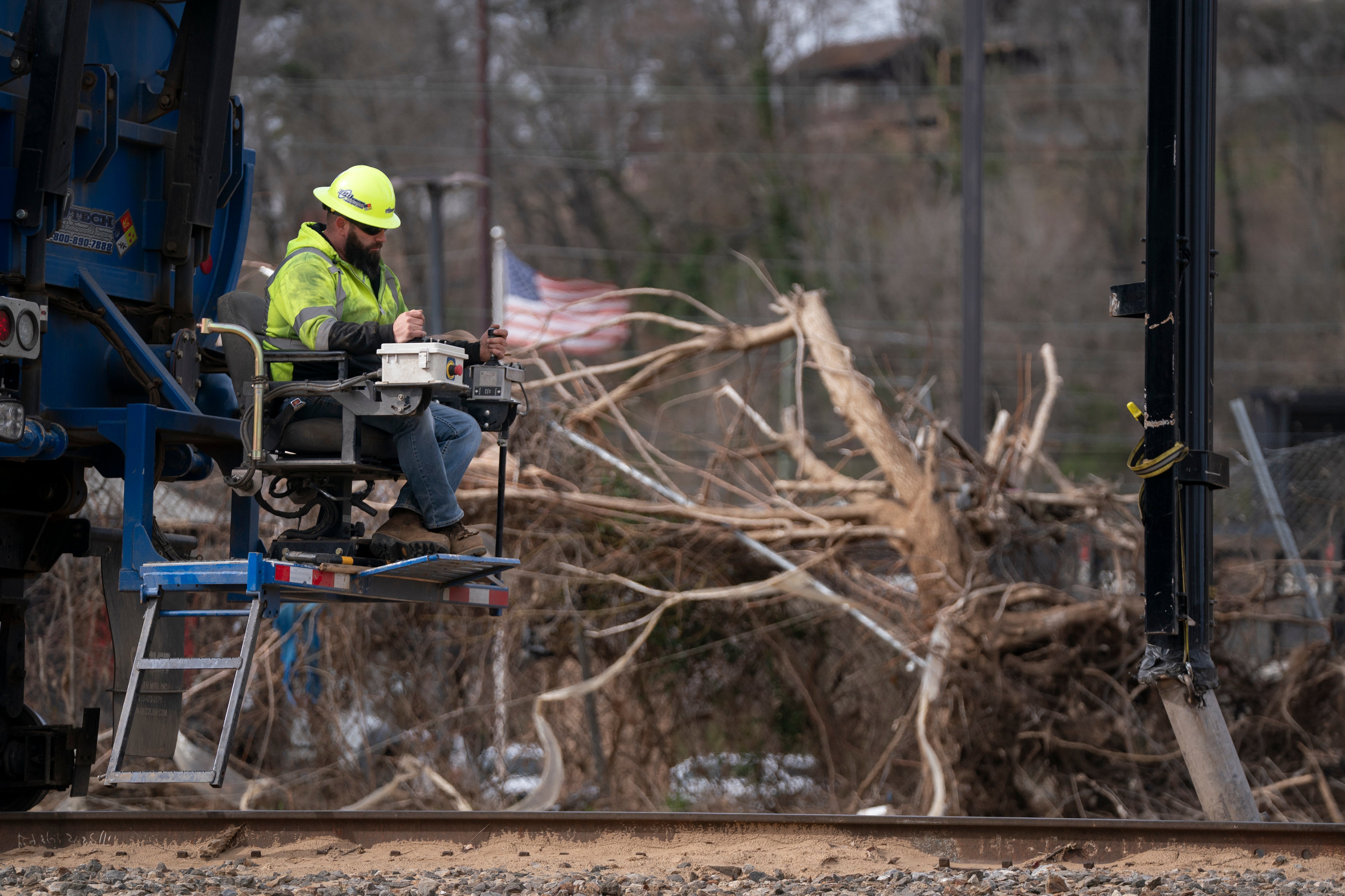 A worker attends to a western North Carolina rail road amid debris from Hurricane Helene. The area is set to see the first ‘noteworthy flooding threat’ since September this week