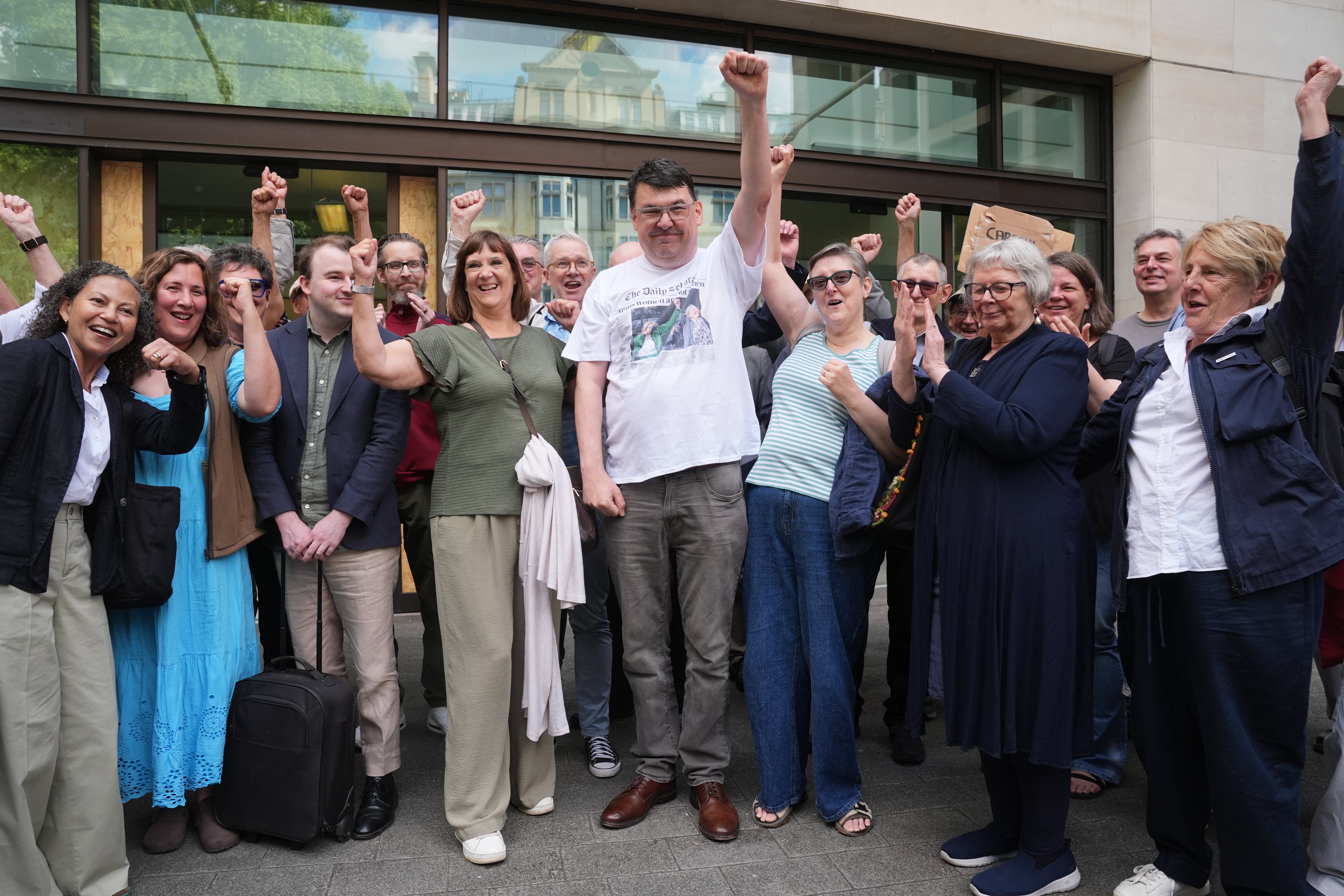 Graham Linehan, centre, poses with supporters outside Westminster Magistrates’ Court