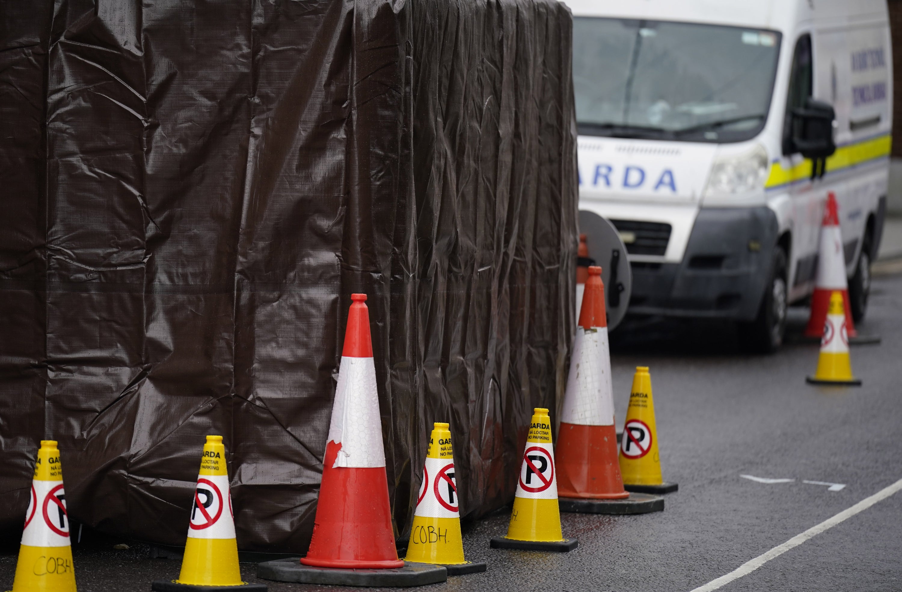 Garda vehicles parked in Youghal (Niall Carson/PA)