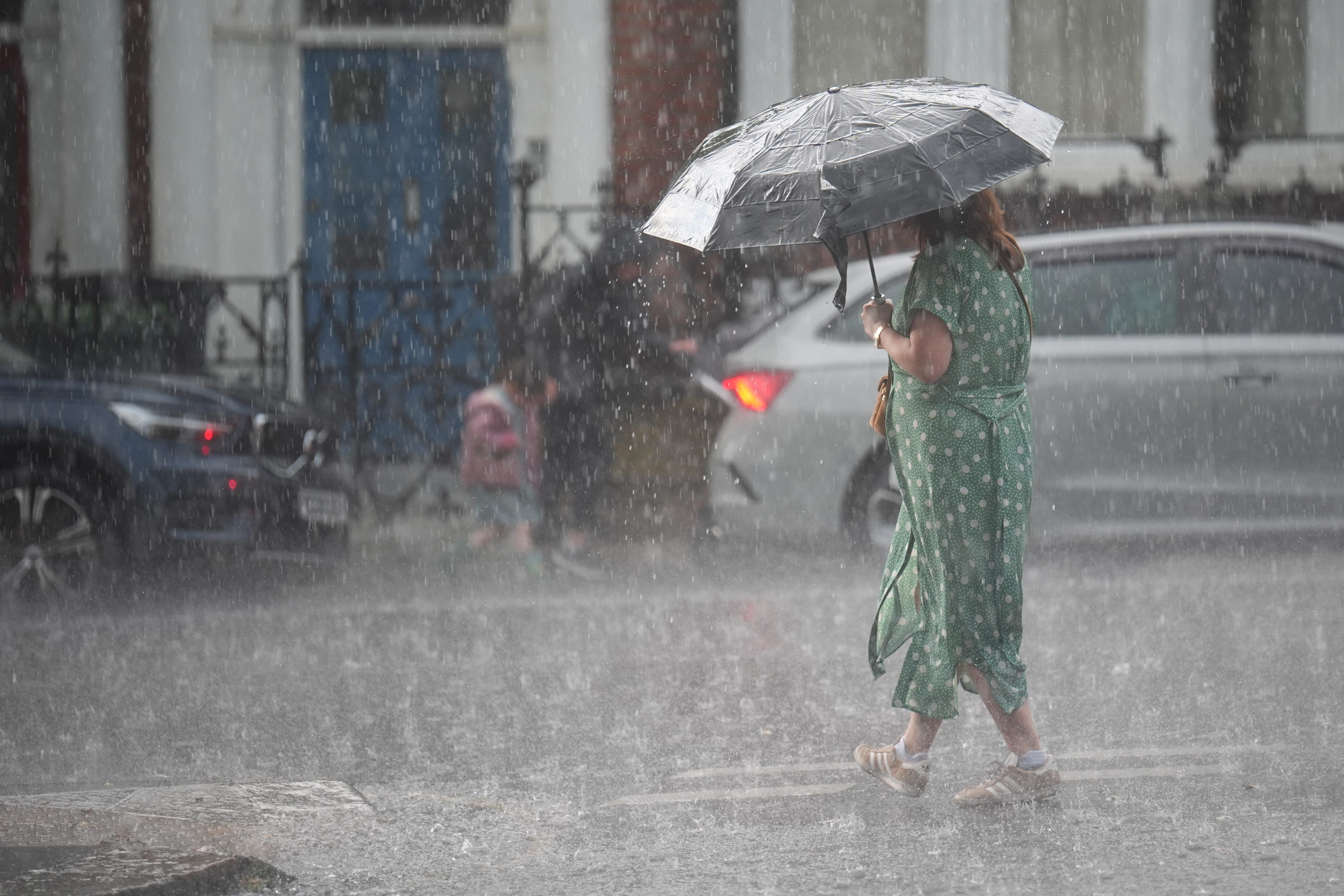 A person walks in the rain through in Kentish Town, north London (James Manning/PA)