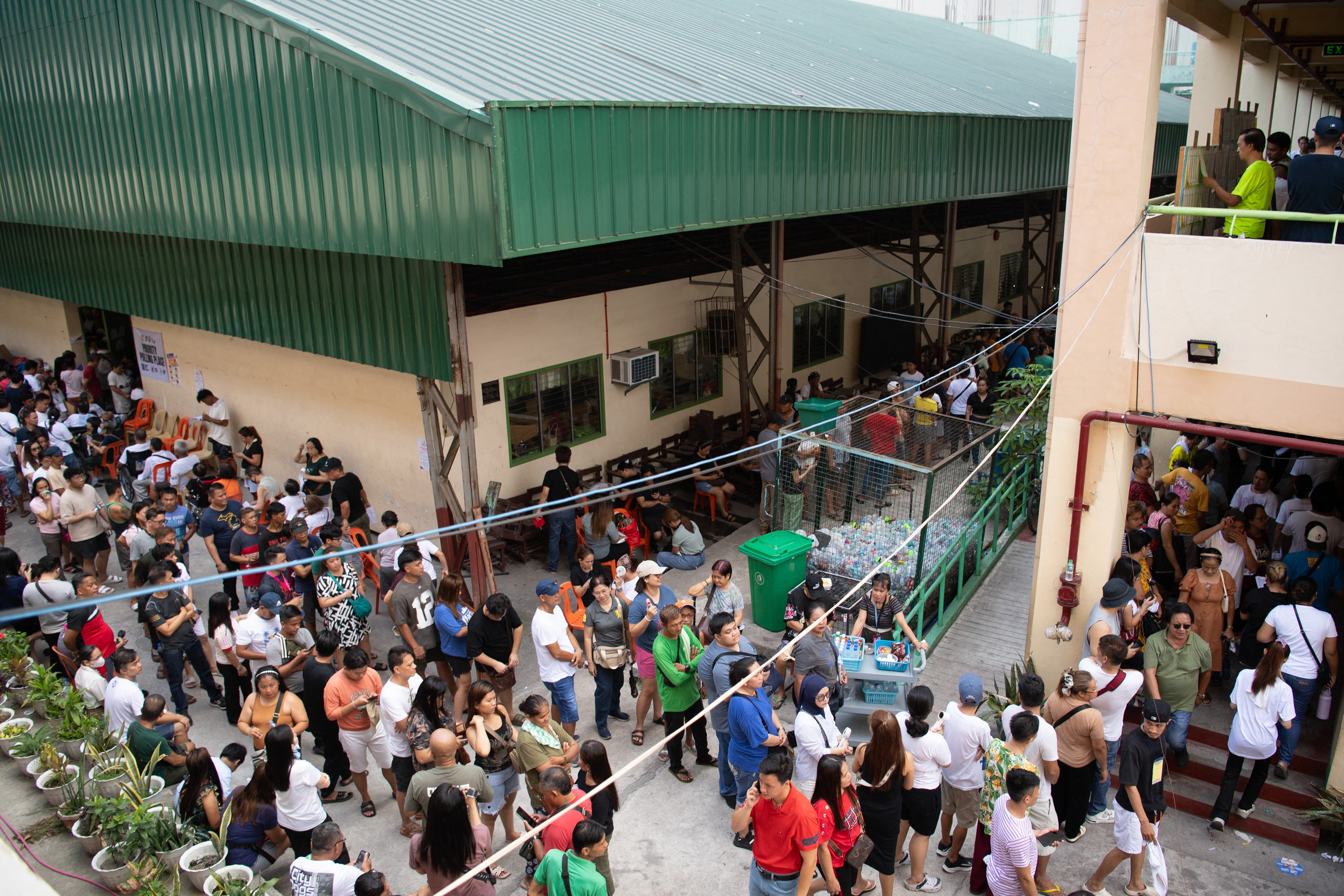 People gather to vote in the mid-term election at a polling station in Manila