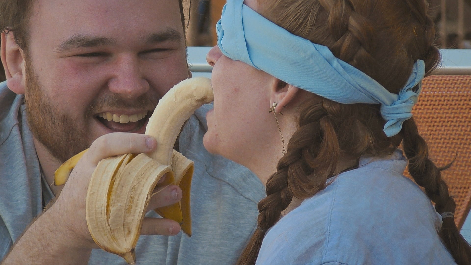 Zac, 28, feeds a fellow participant a banana