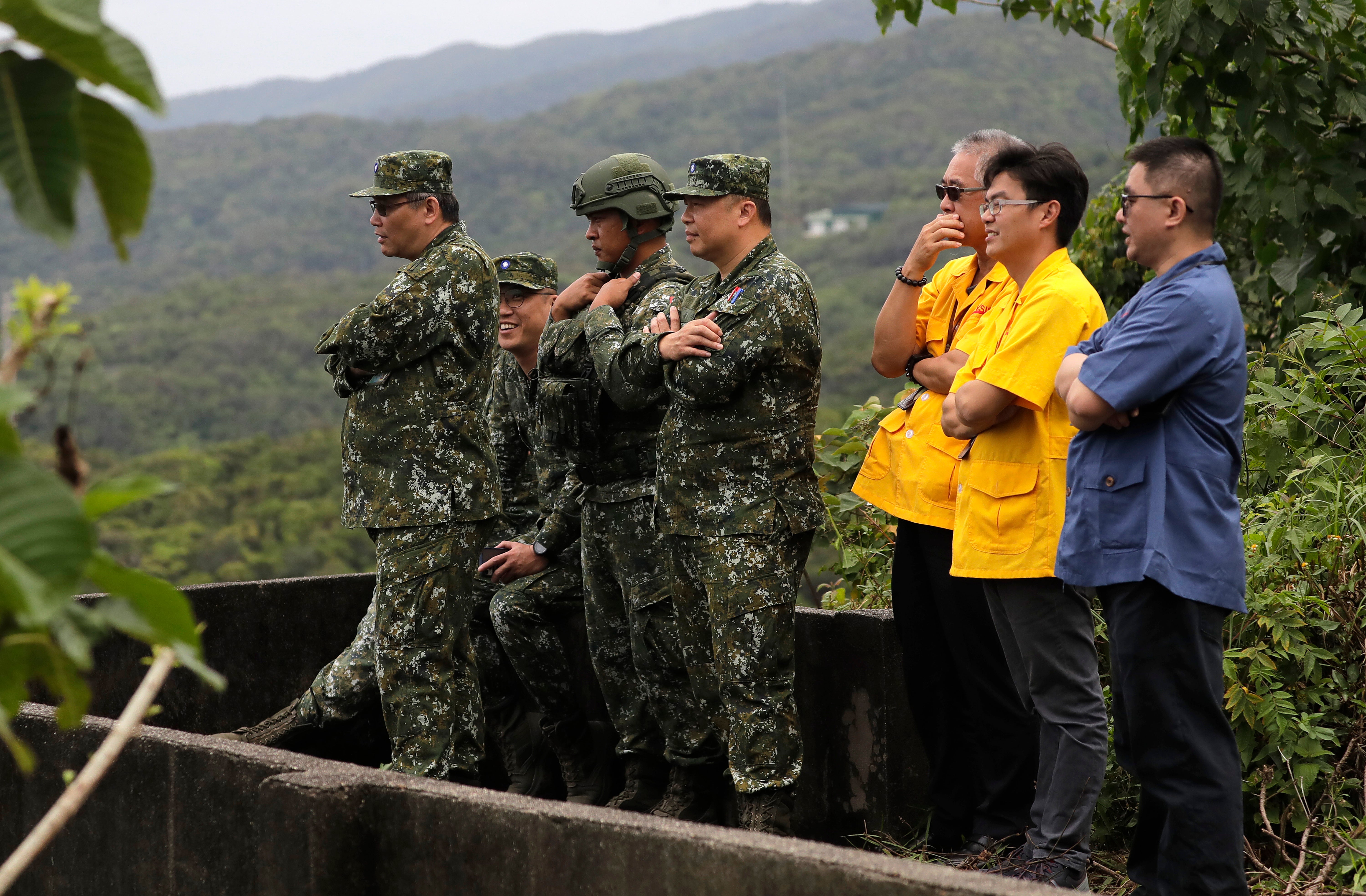 Military and technical personnel watch, during the M142 High Mobility Artillery Rocket System (HIMARS) testing drill in Pingtung County, Southern Taiwan