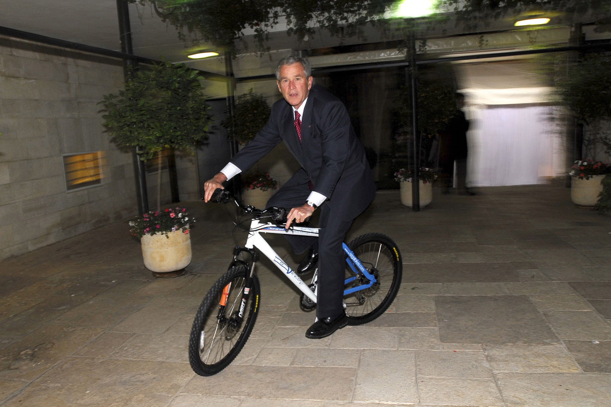 George W. Bush riding a bicycle gifted from Israeli Prime Minister Ehud Olmert in 2008