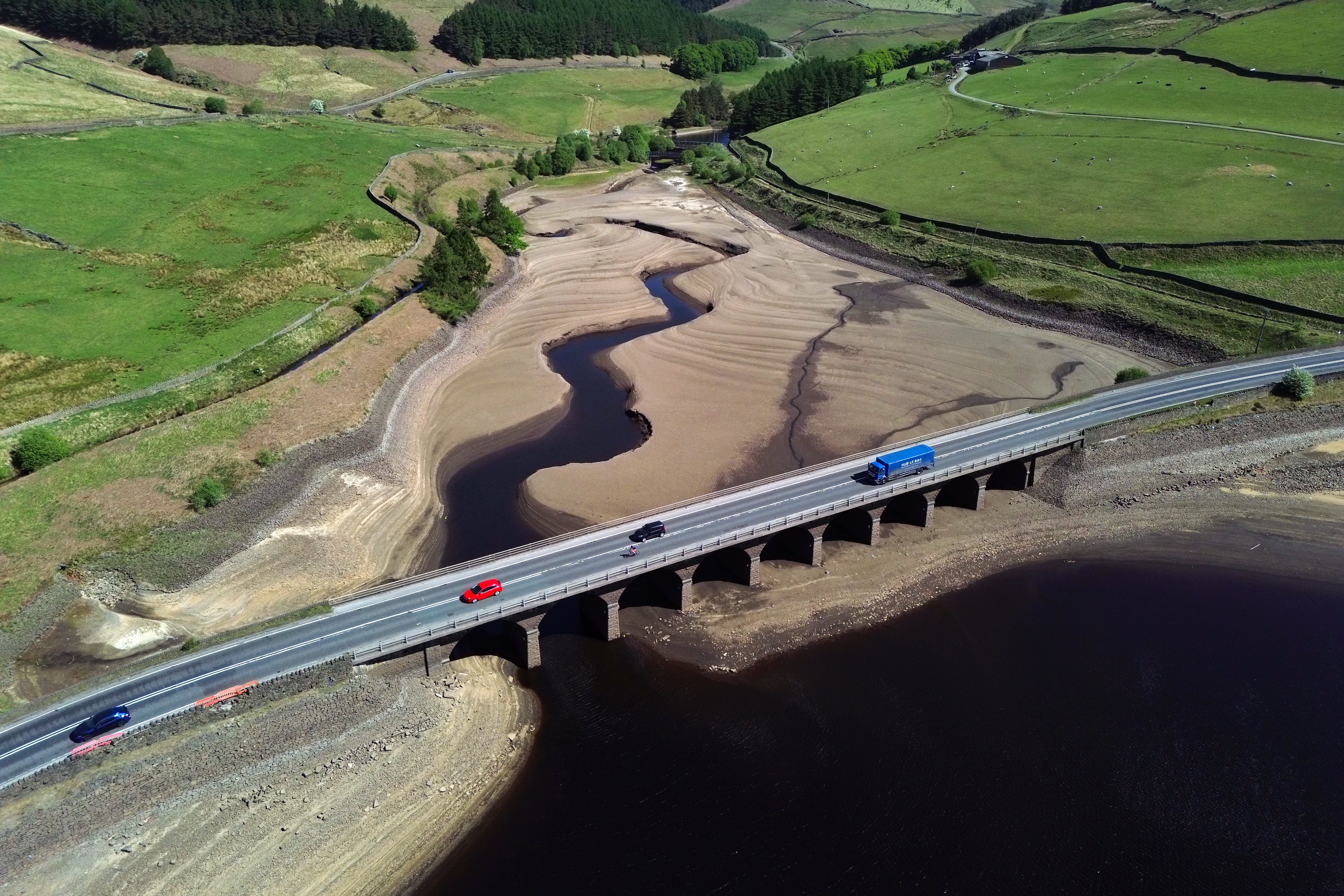 An aerial photograph shows the partially revealed bed of Woodhead Reservoir in Derbyshire