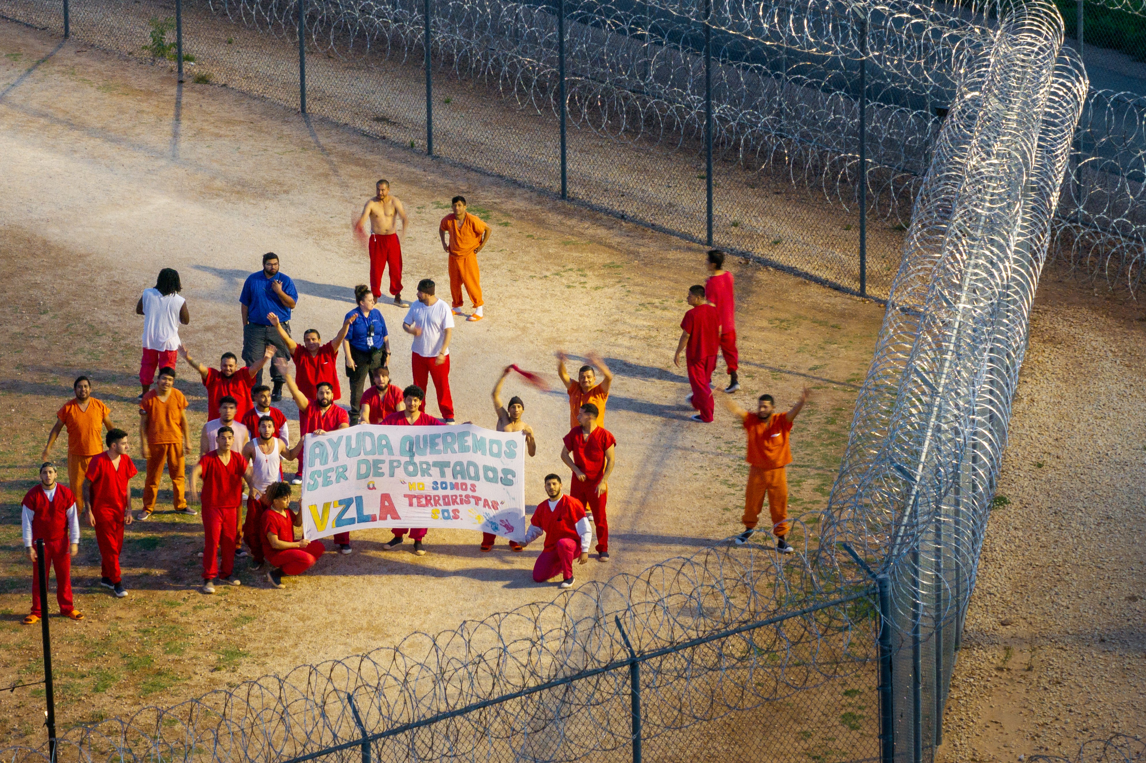 A drone image captures a group of immigrants imprisoned at the Bluebonnet Detention Center in Texas holding up a sign reading ‘we are not terrorists’