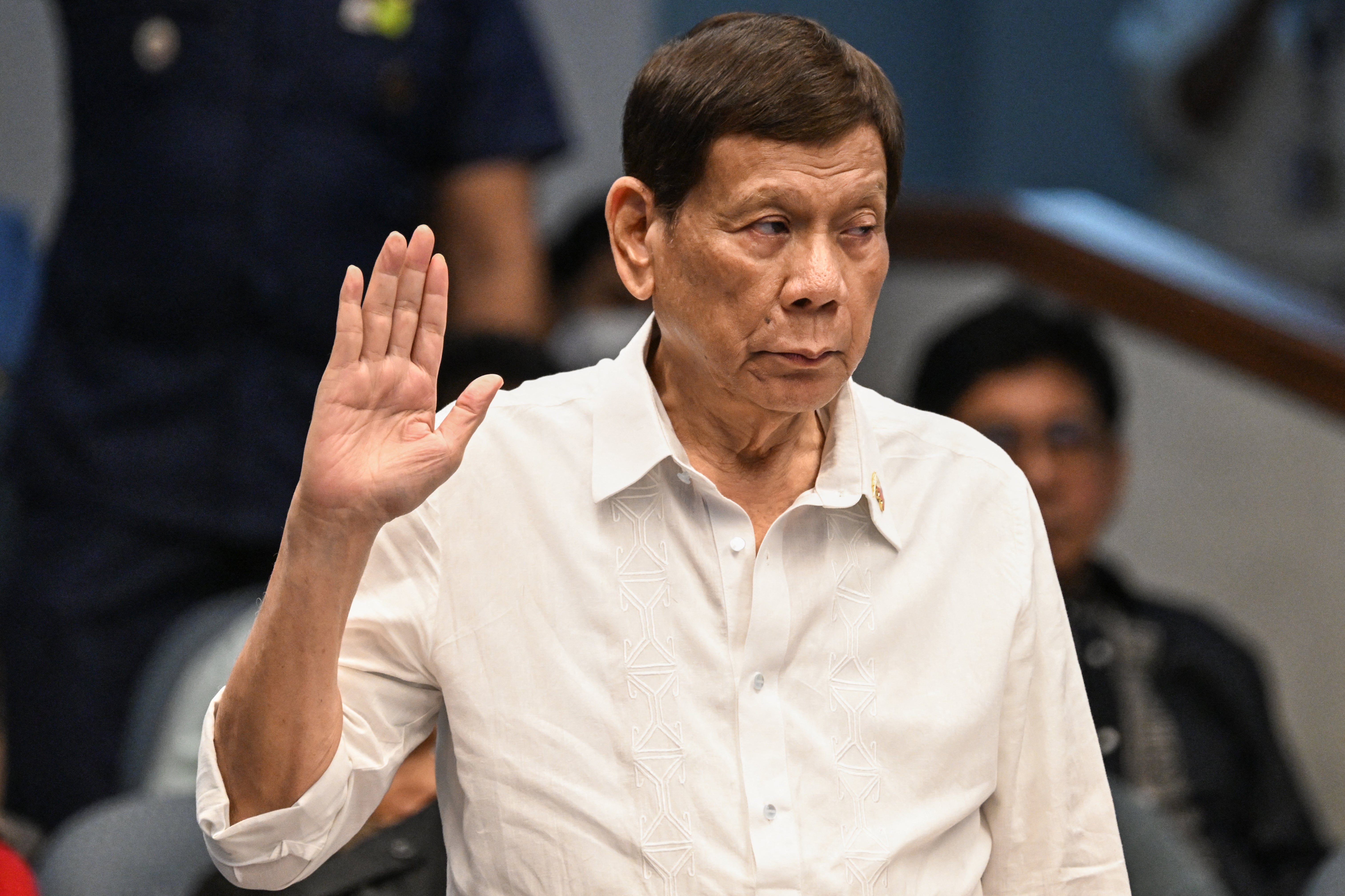 Former Philippine president Rodrigo Duterte takes an oath as he attends a senate probe on the drug war during his administration, in Manila