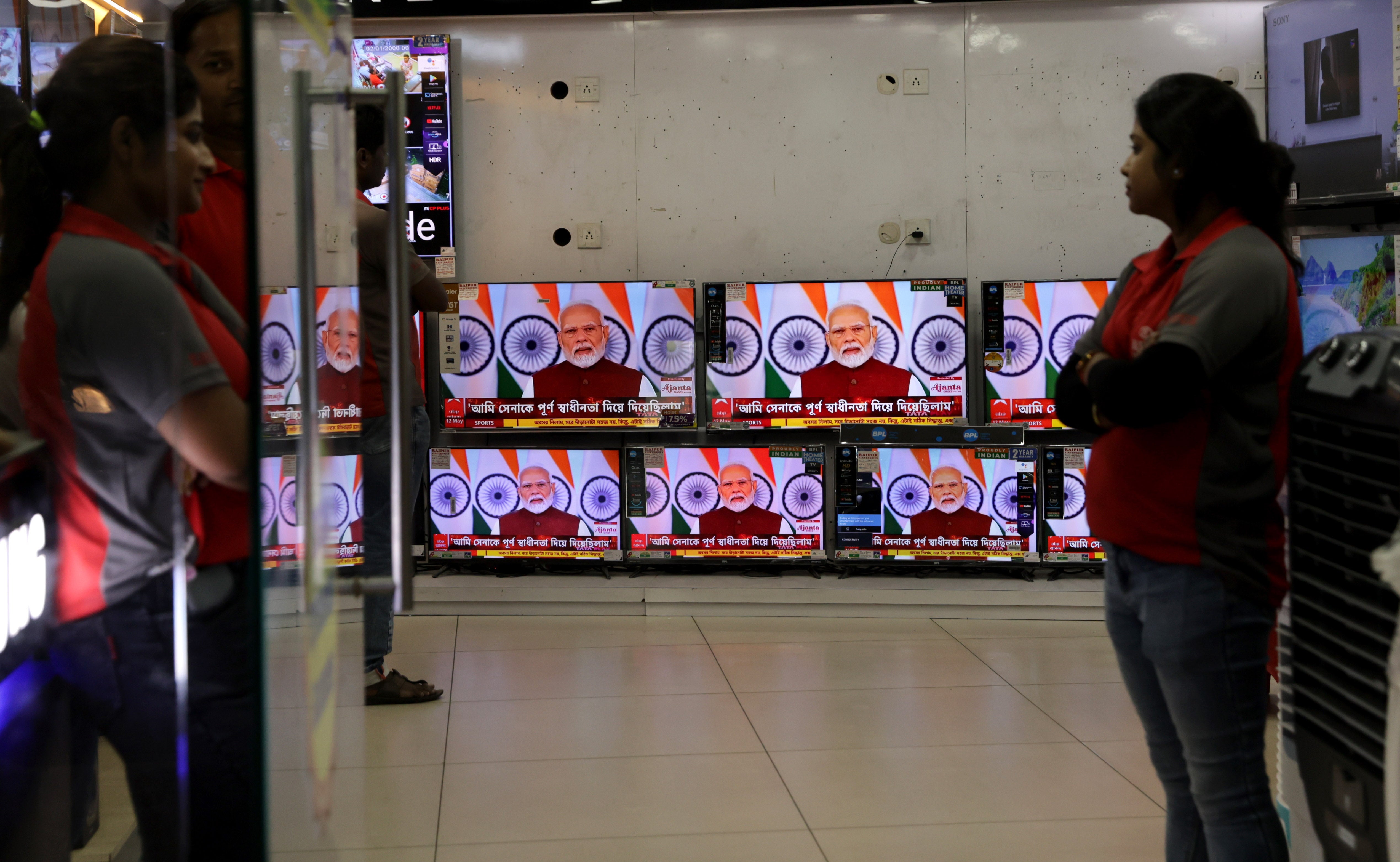 Television screens show a live telecast of Indian prime minister Narendra Modi addressing the nation for the first time since recent escalations in the India-Pakistan conflict