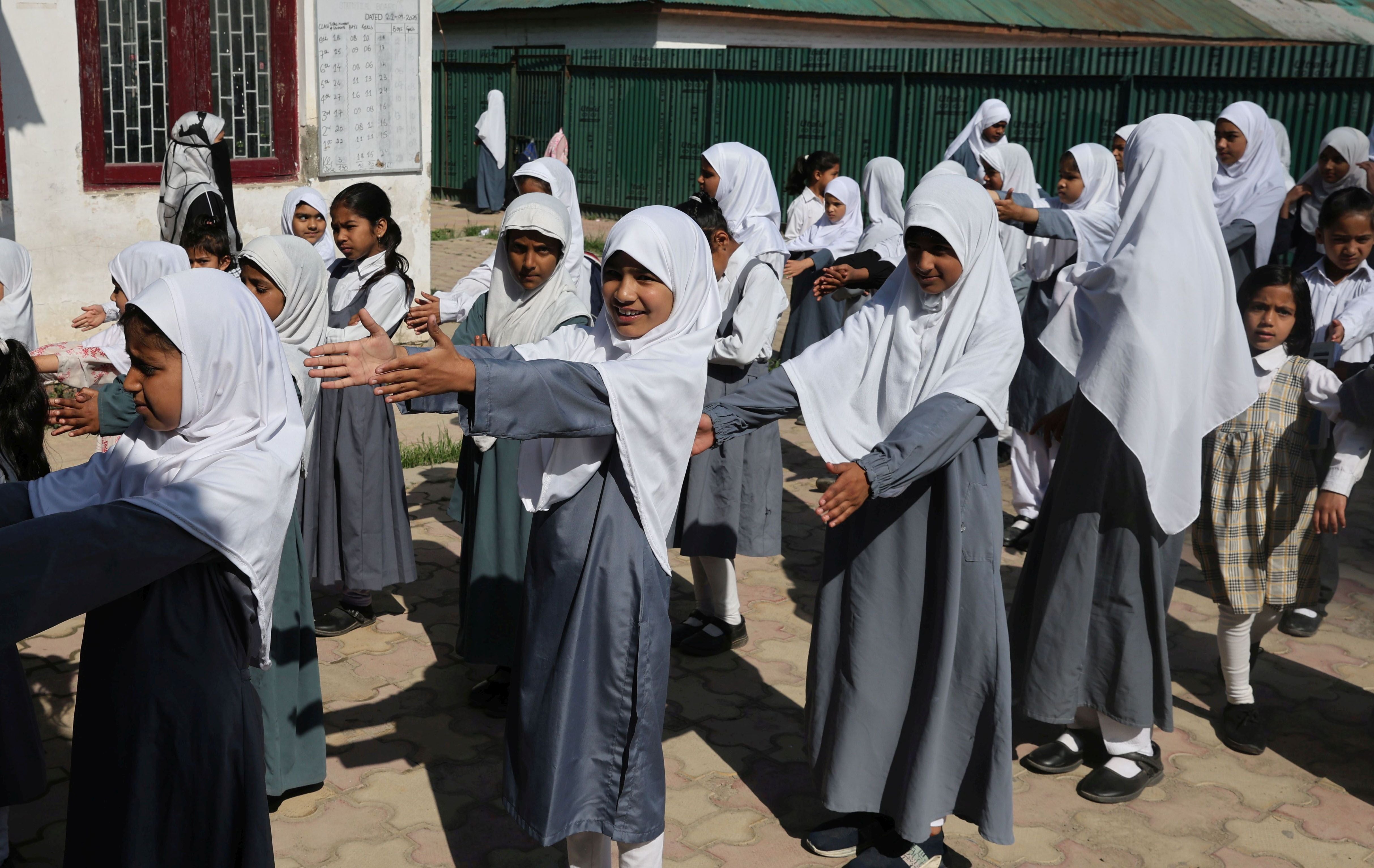 Students exercise during the morning assembly at their school, following its reopening after the Pakistan-India ceasefire, in Srinagar, India, 13 May 2025