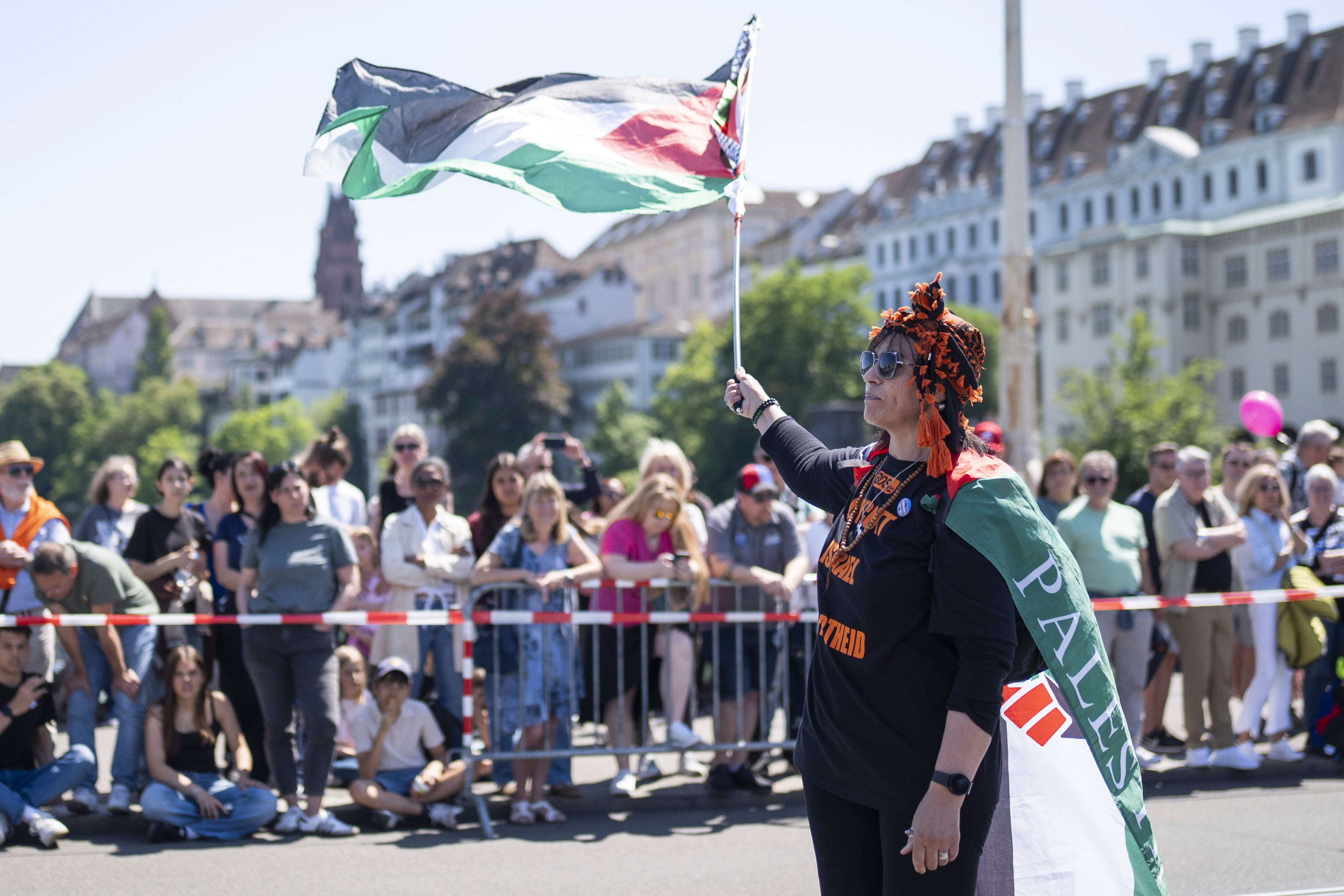 A protester raises a Palestinian flag during the opening ceremony of the 69th Eurovision Song Contest in Basel, Switzerland, on Sunday