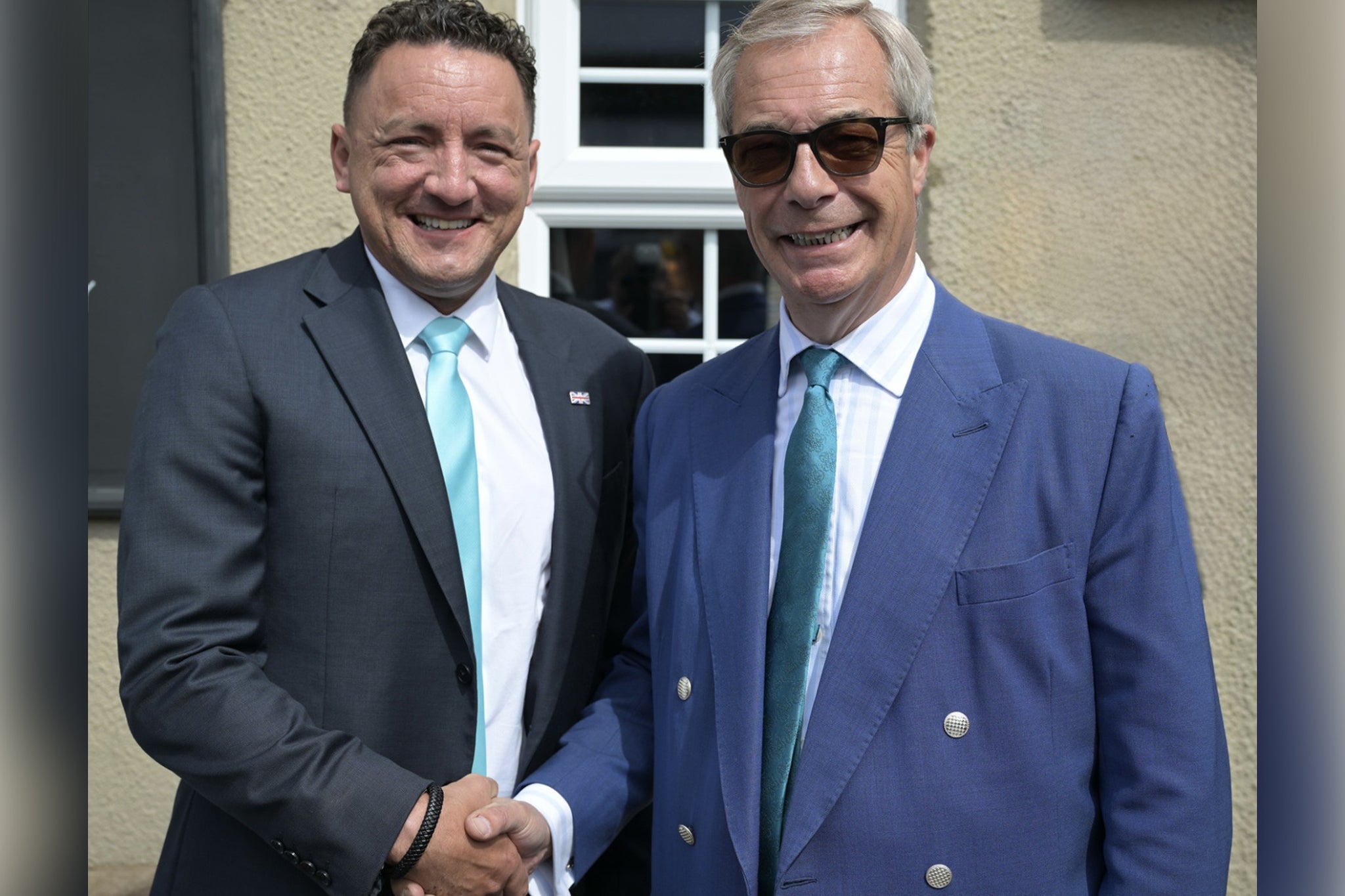 Andrew Hamilton-Gray shakes hands with the leader of Reform UK Nigel Farage