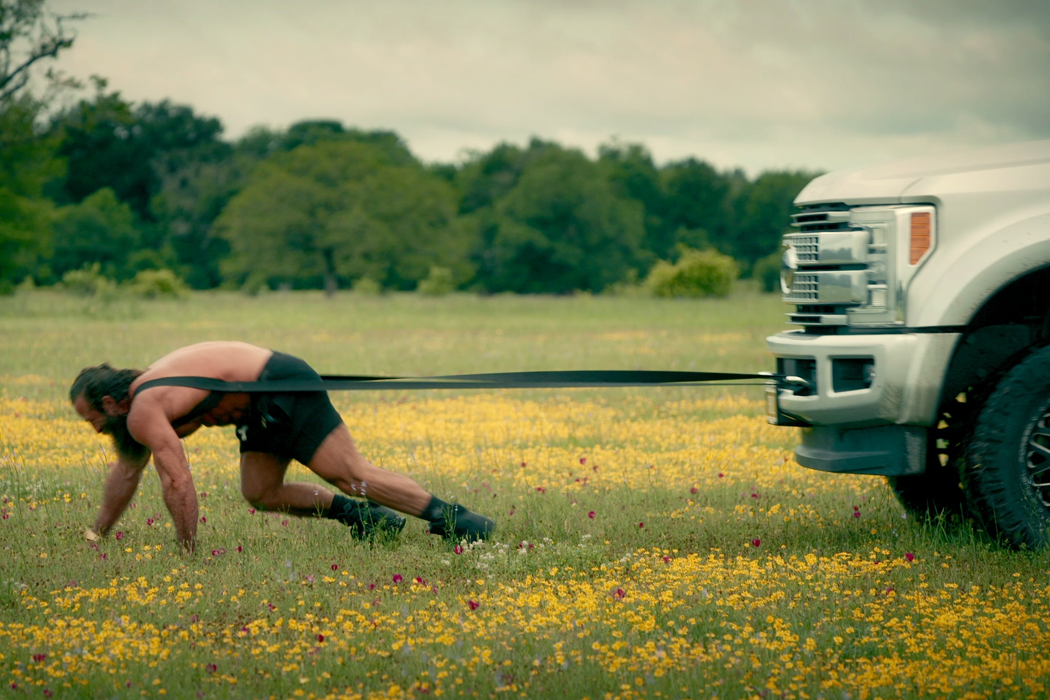A typical Liver King stunt sees him dragging a 4x4