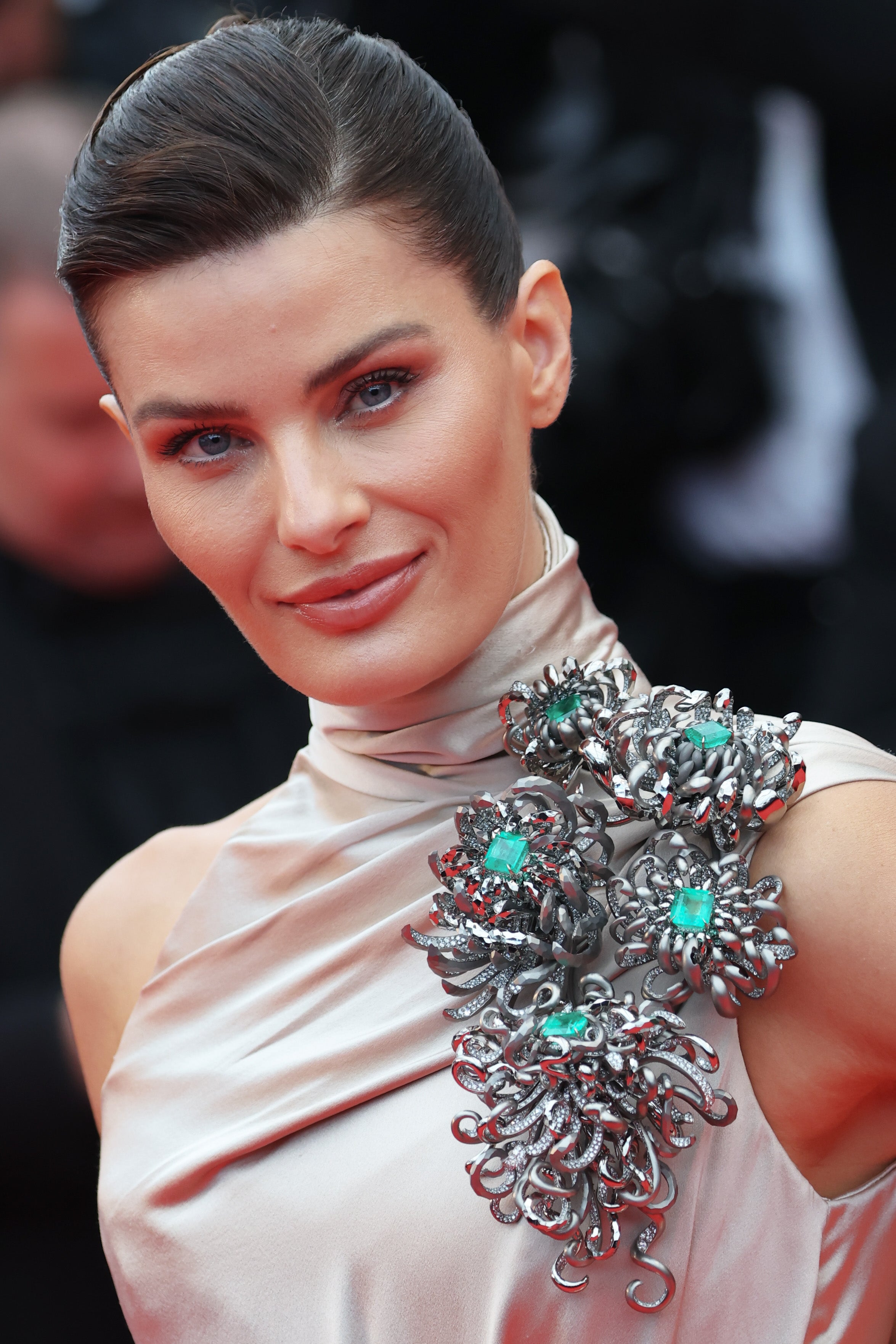 The turtleneck, floor-length dress included a high slit and a spikey, turquoise brooch crawling around her left shoulder