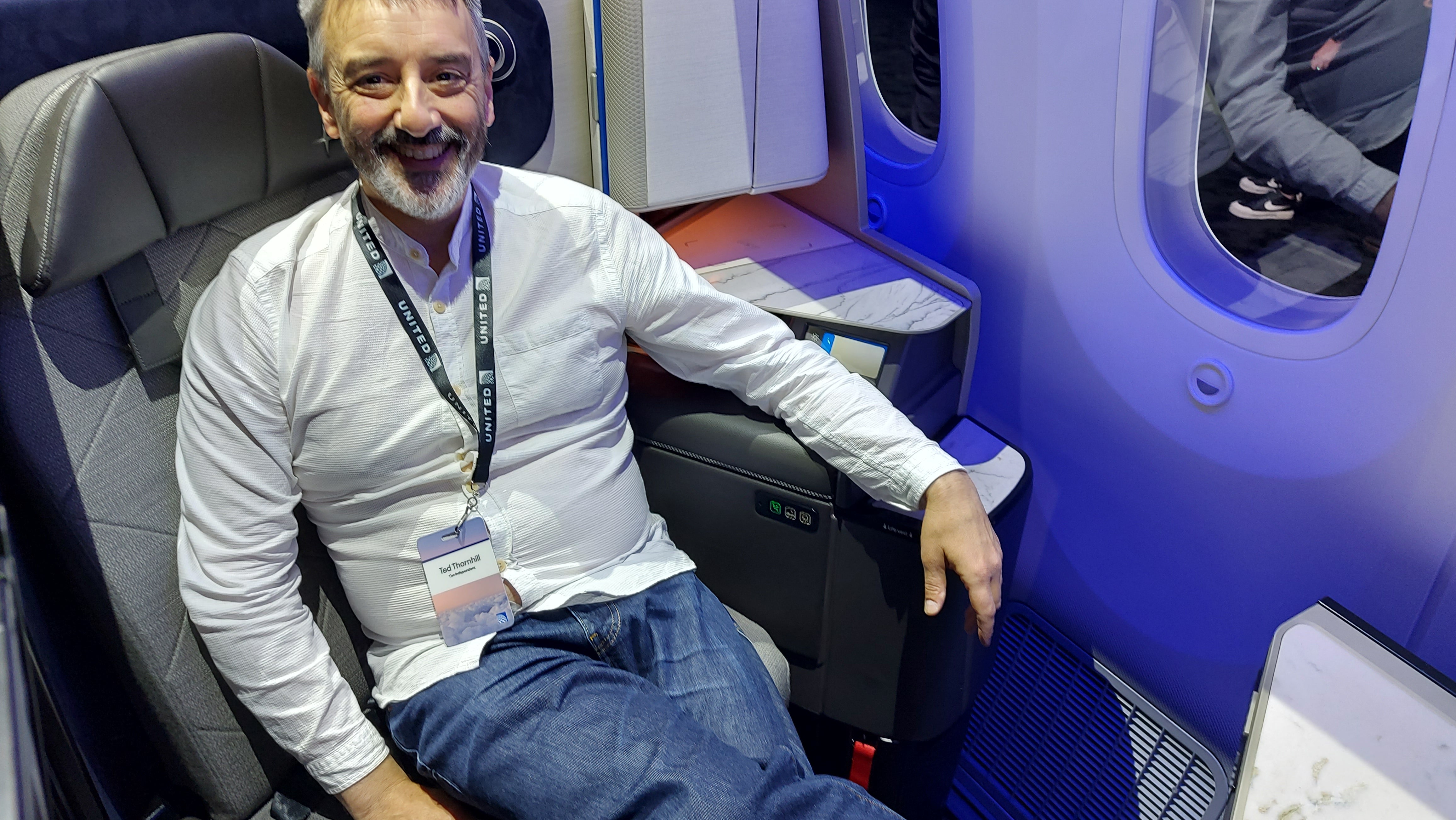 <p>The Independent's Ted Thornhill tries out United Airlines' new Dreamliner seats at a launch event in Brooklyn. He's pictured above in a working version of the new Polaris Studio business-class seat
</p>