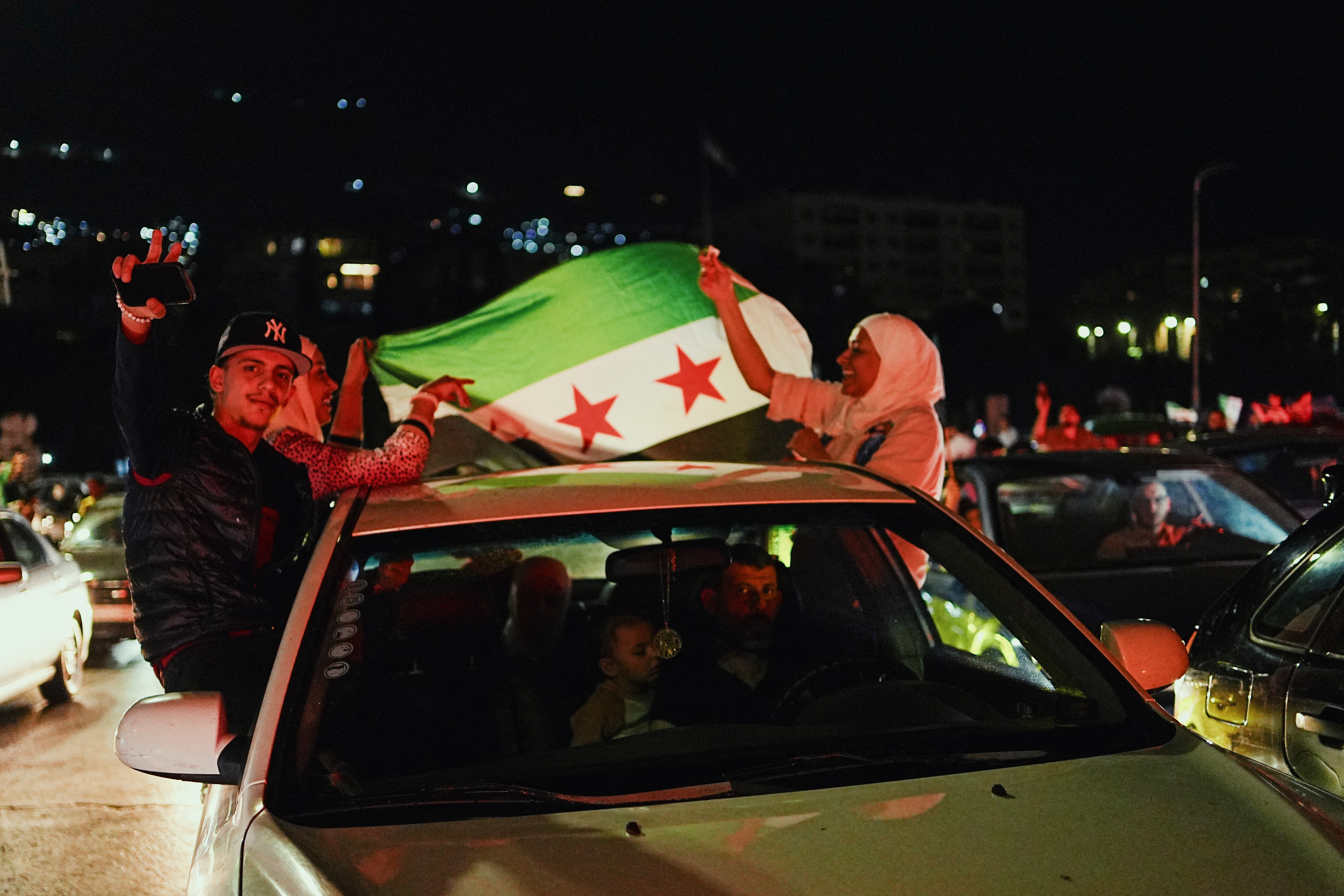 People celebrate in Damascus' Omeyyad square after US President Donald Trump's decision to lift sanctions in Syria, on May 13, 2025.