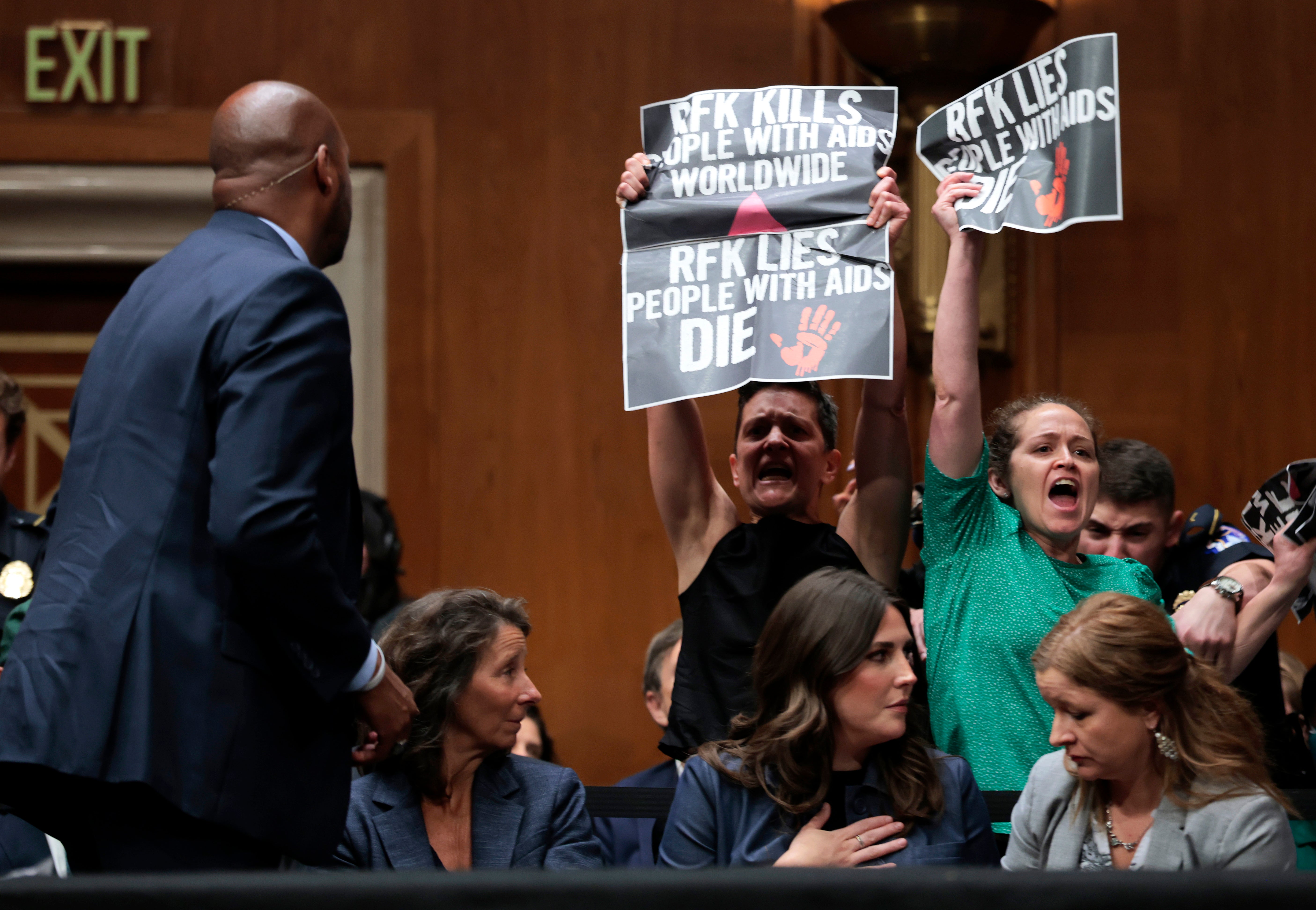 Protesters holding posters reading: ‘RFK lies, people with AIDS die’
