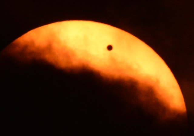 <p>Clouds partially obscure the sun during the transit of Venus June 5, 2012 as seen from Riverside Park on the west side of Manhattan in New York</p>