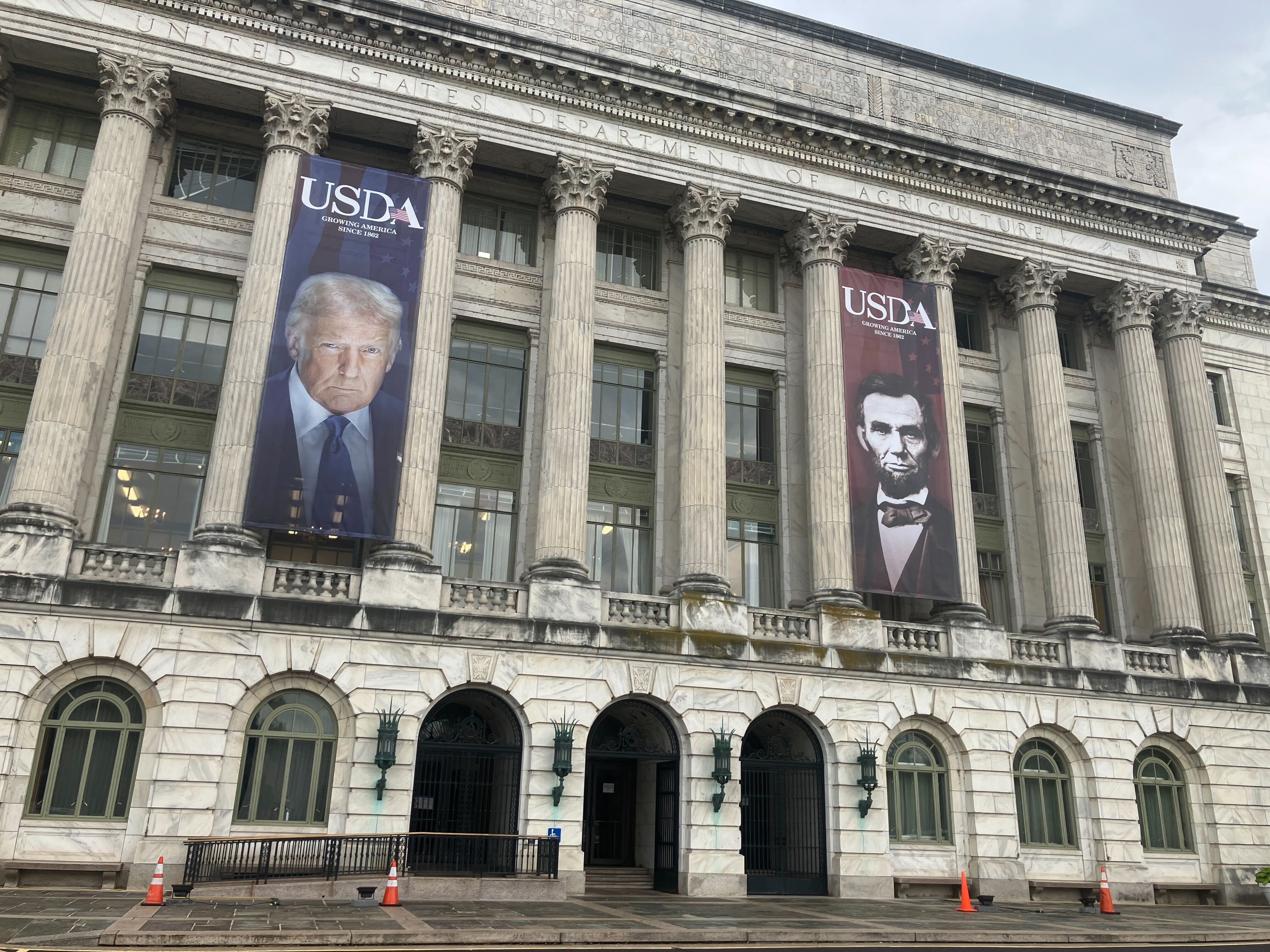 Large banners installed on the facade of the U.S. Department of Agriculture show President Donald Trump and President Abraham Lincoln