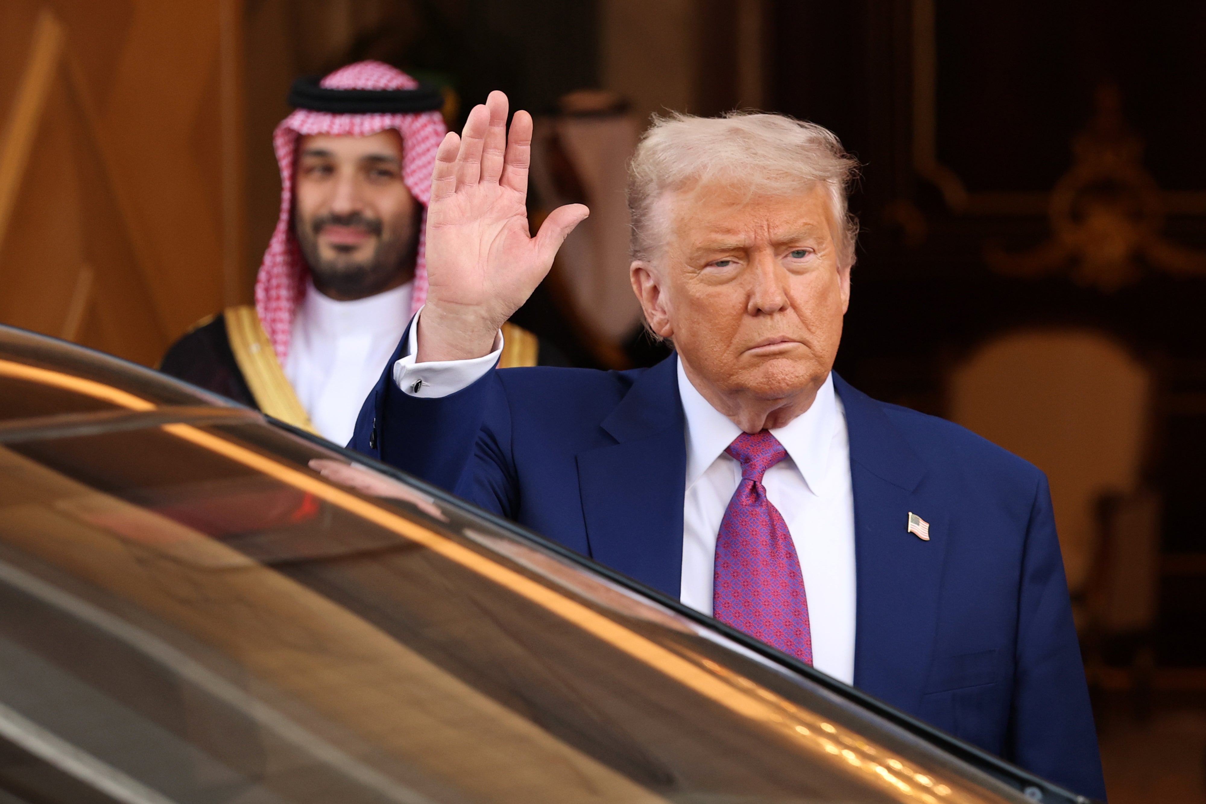 President Donald Trump gives a wave on his Mideast tour Tuesday as Saudi Prince Mohammed bin Salman smiles.