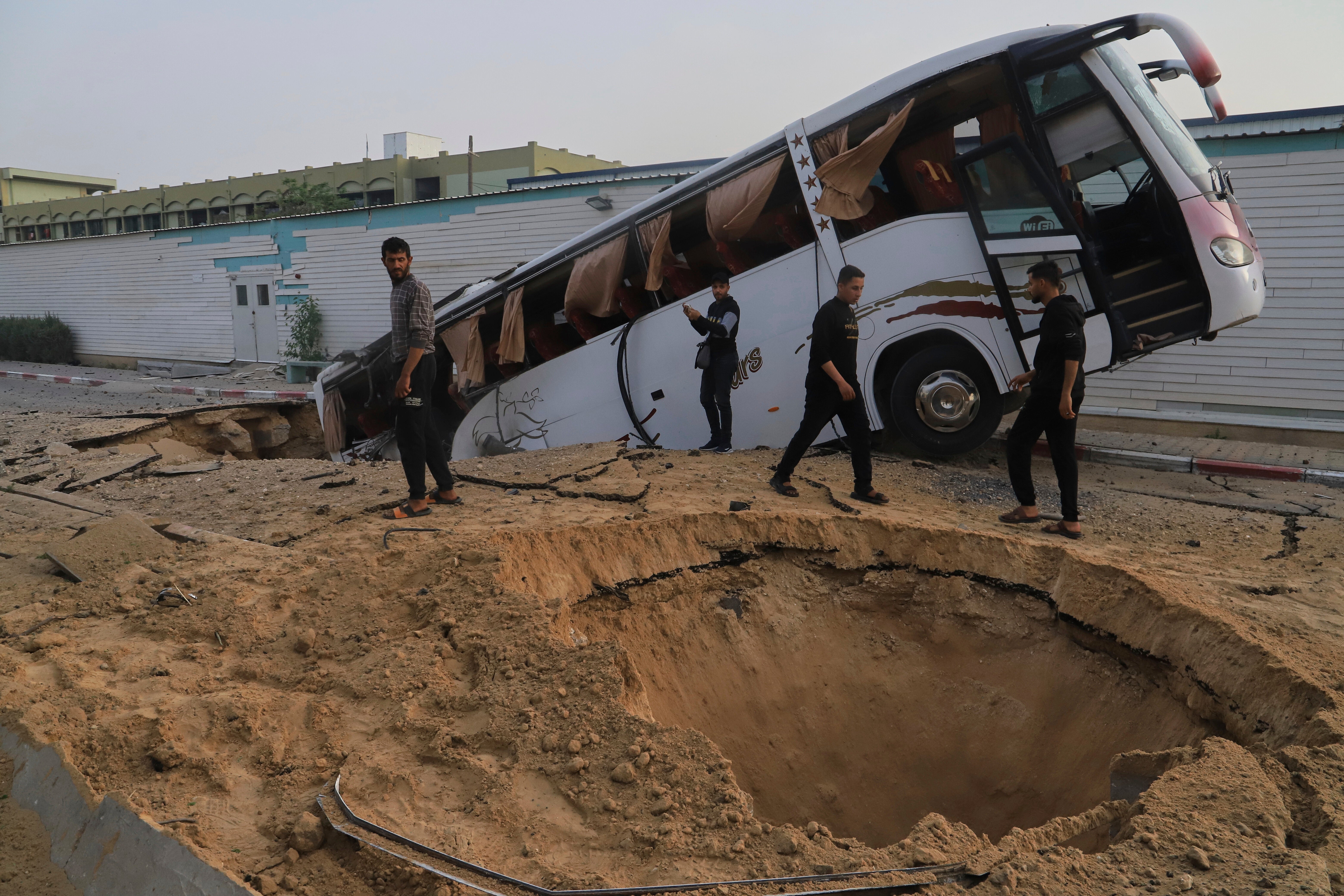 Palestinians inspect the site of an Israeli army airstrike on the European hospital in Khan Younis