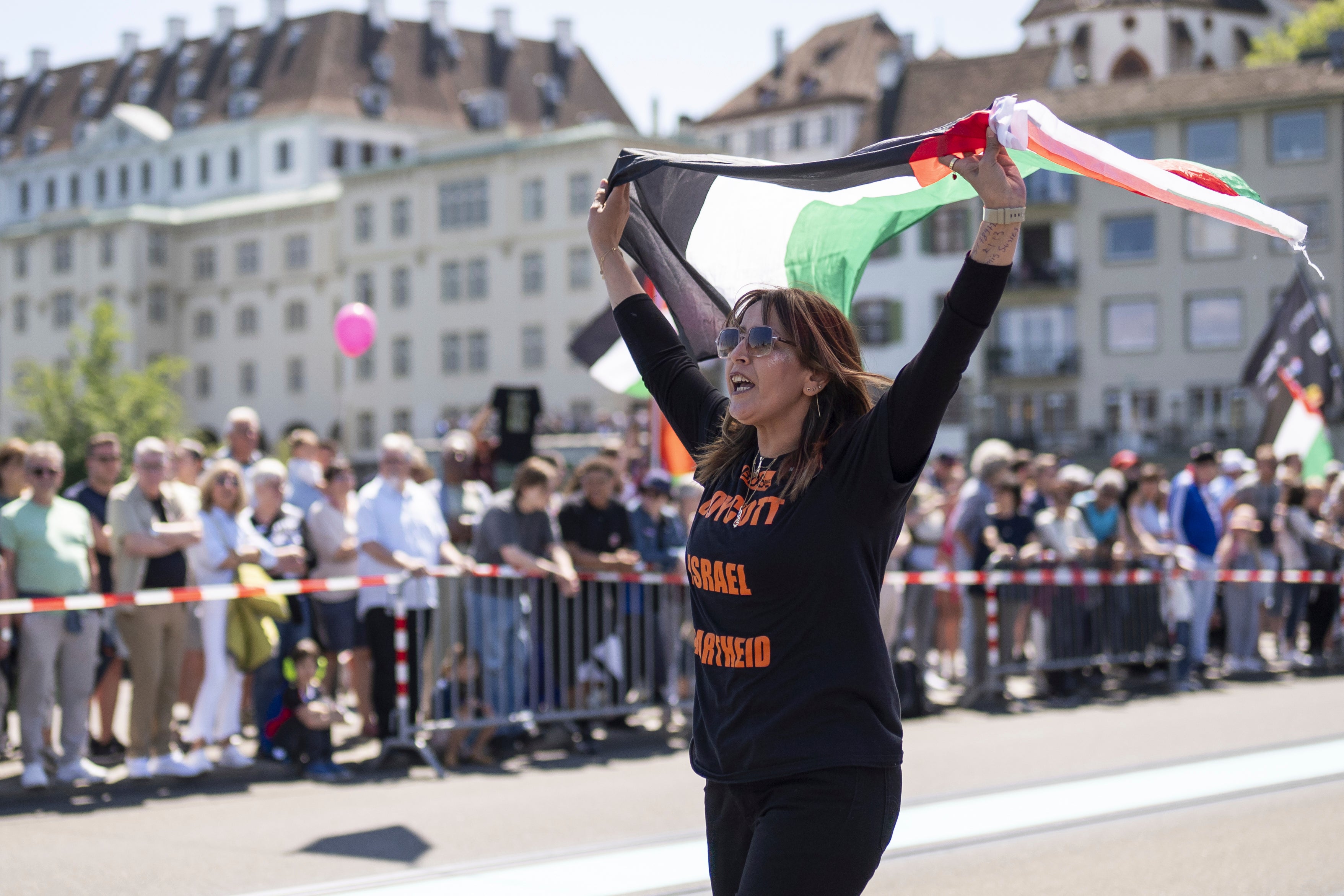 A protester raises a Palestinian flag during the opening ceremony of the 2025 Eurovision Song Contest, in Basel, Switzerland
