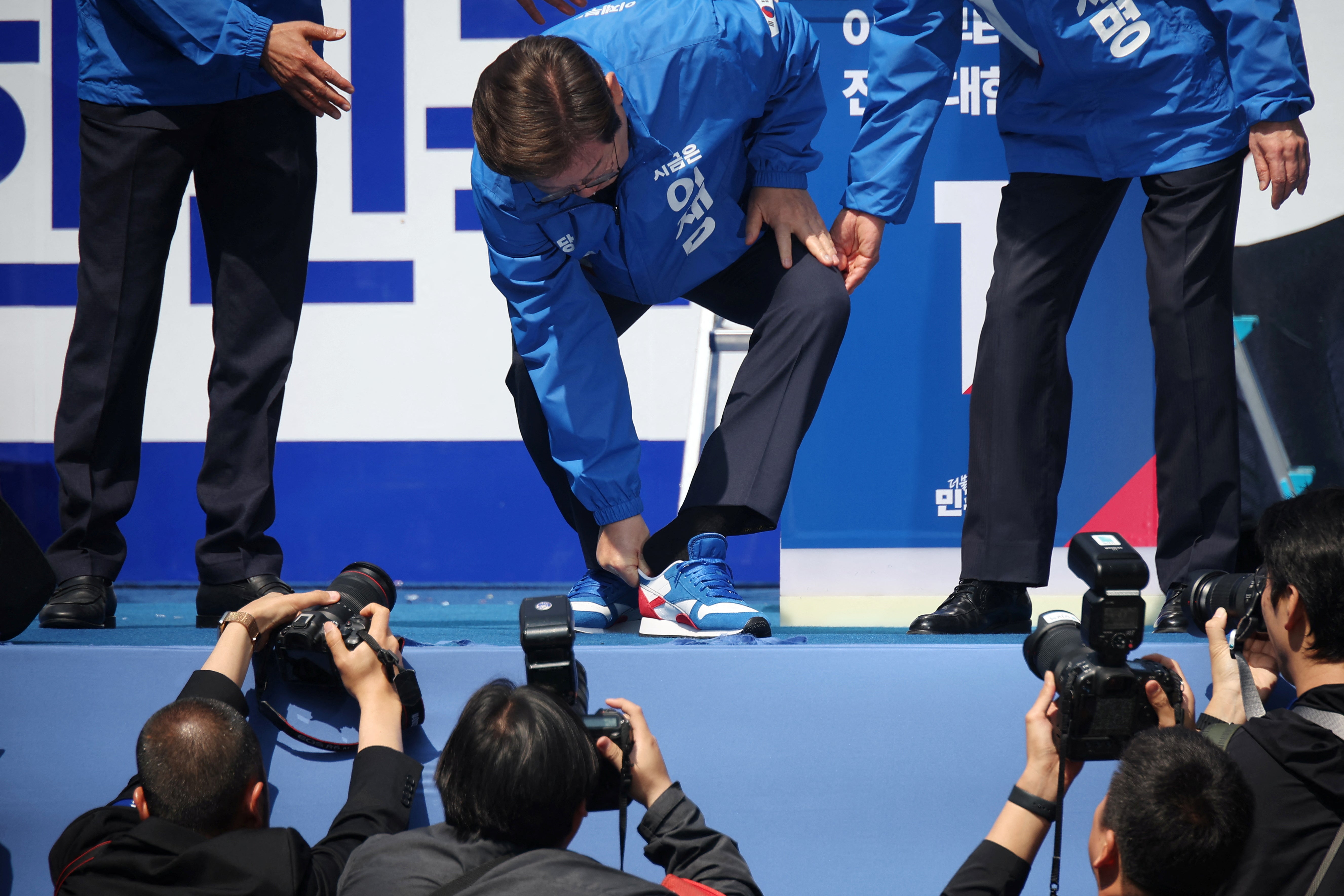 Lee sports his South Korean-coloured shoes during an election campaign rally in May