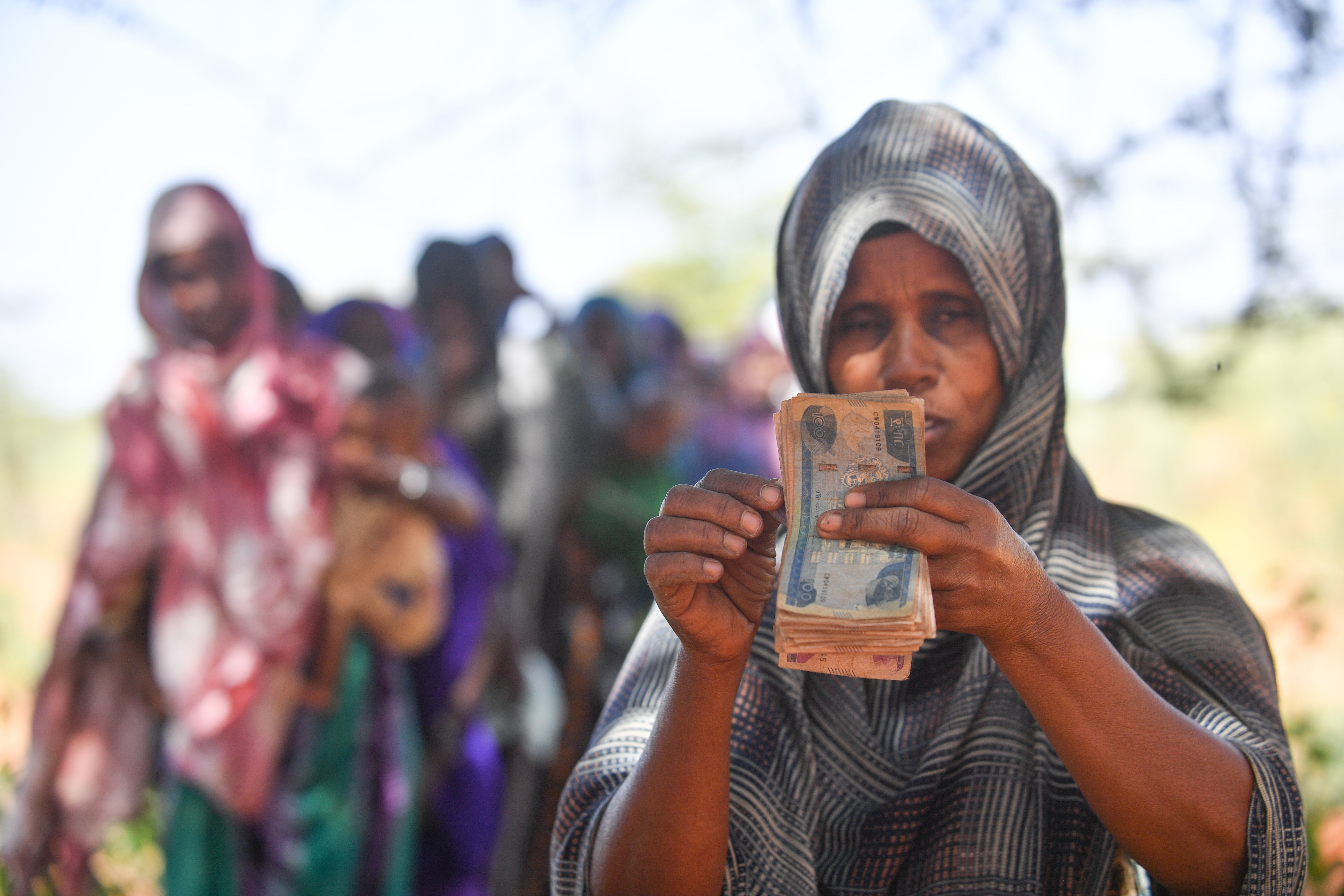Habiba Abdulahi seen receiving cash during the anticipatory action cash distribution process in Somali Region, Ethiopia