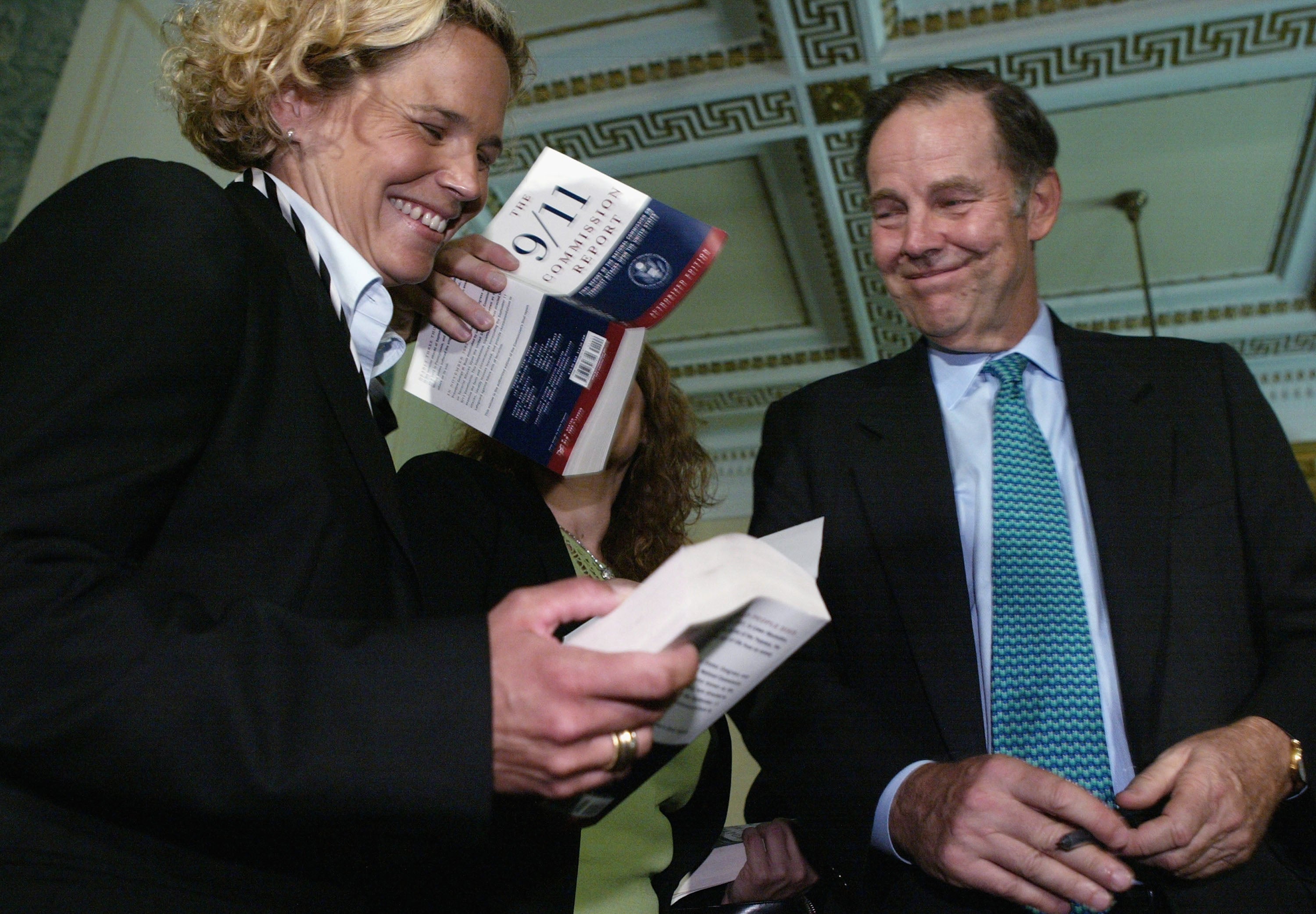 September 11 widow Kristen Breitweiser (left), seen here with 9/11 Commission Chairman and former New Jersey Gov. Tom Kean, has focused her ire on U.S. intelligence agencies, not the Saudis.