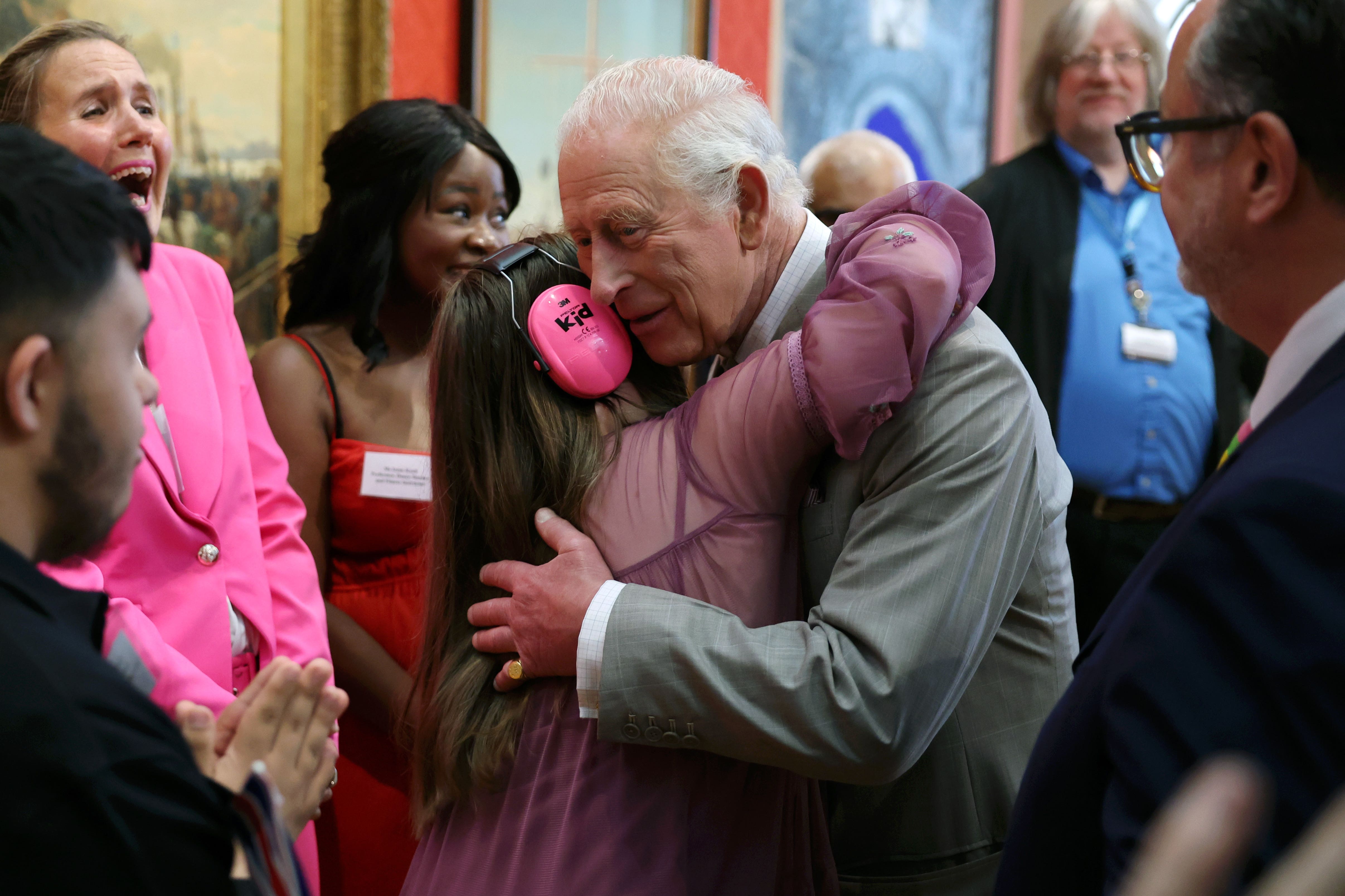 Charles gets a hug from Florence McGrellis during a visit to Cartwright Hall in Bradford (Chris Jackson/PA)