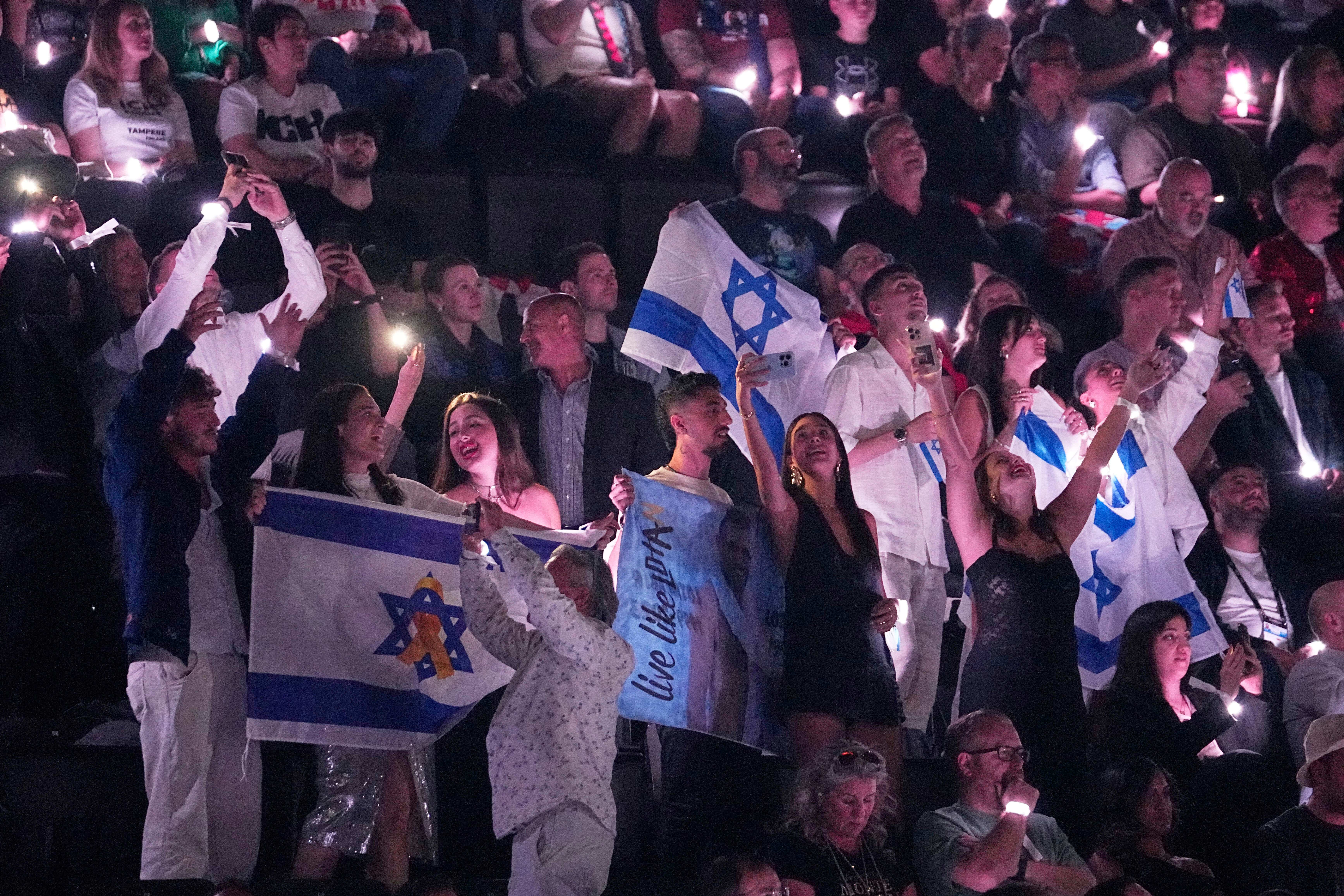 Israeli fans cheer for Yuval Raphael from Israel. (AP Photo/Martin Meissner)