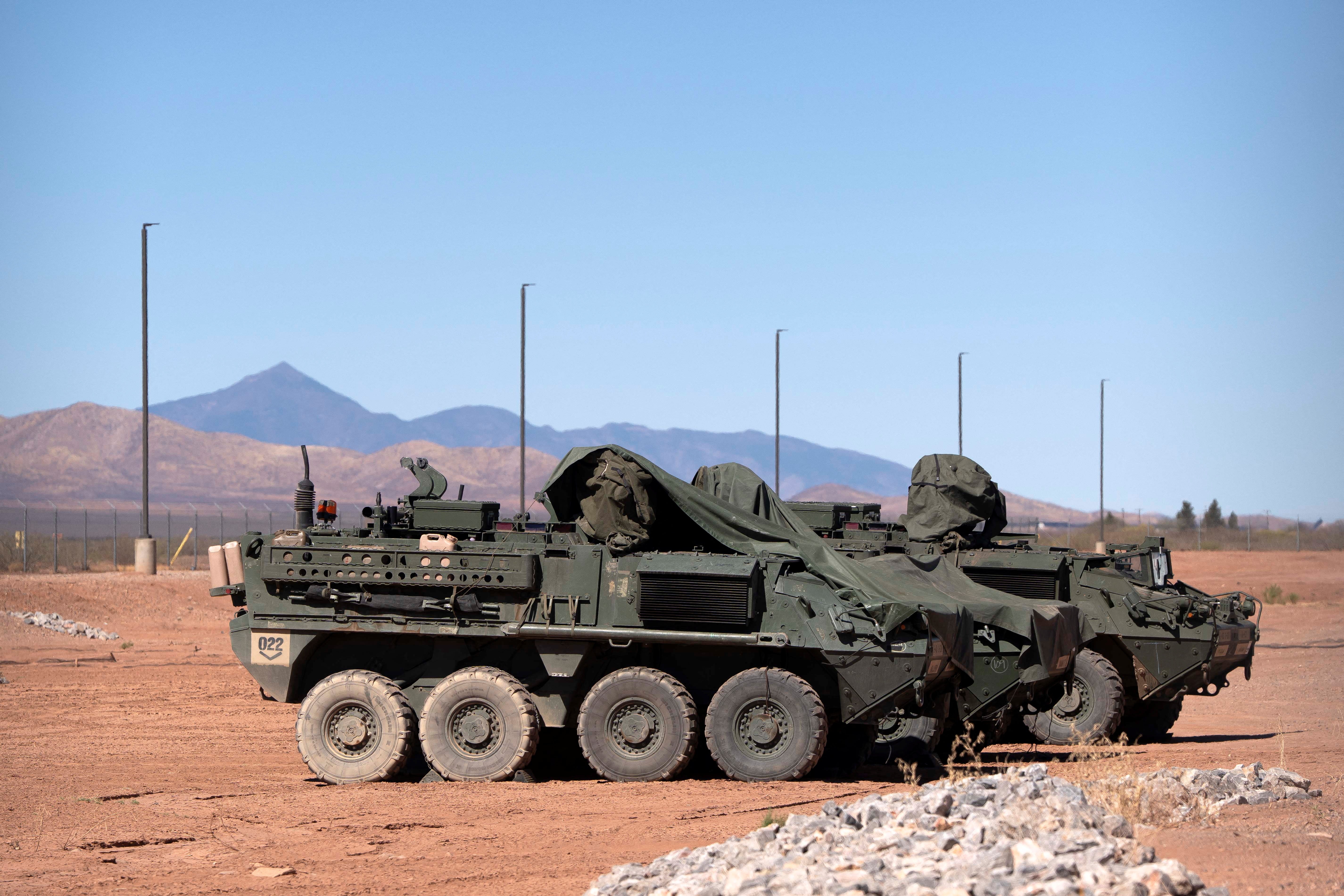 U.S. military Stryker vehicles sit in a fenced area at a U.S. Customs and Border Protection facility in Douglas, Arizona