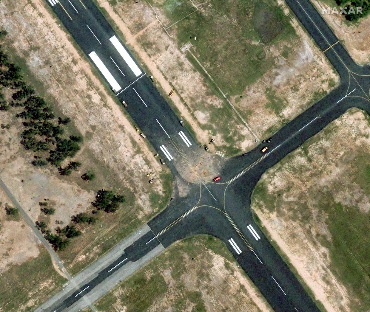 A satellite image shows a view of the response crew vehicles at damaged runway of PAF Base Mushaf