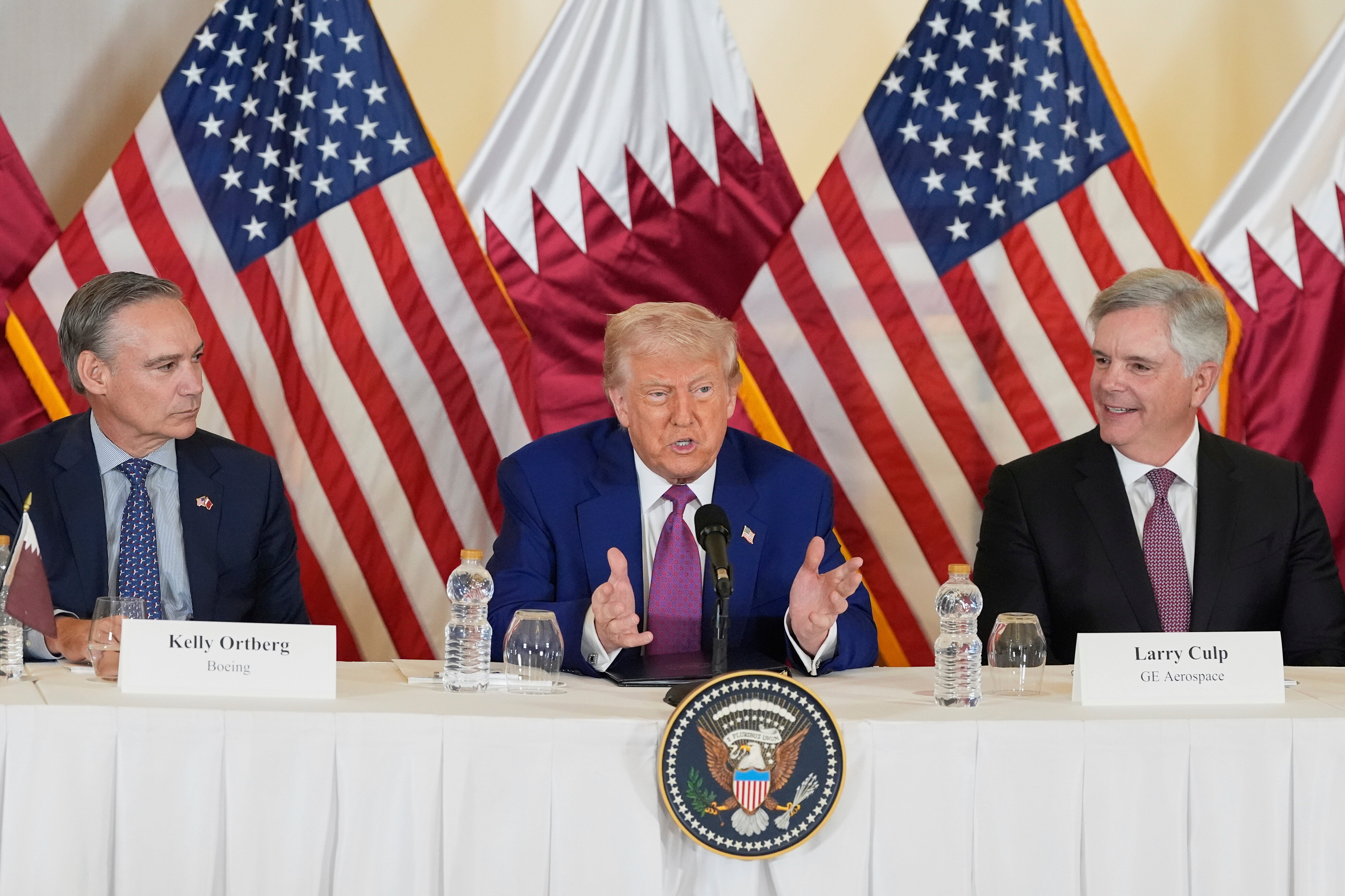 President Donald Trump speaks, seated between Boeing CEO and president Kelly Ortberg, left, and Larry Culp, CEO of GE Aerospace