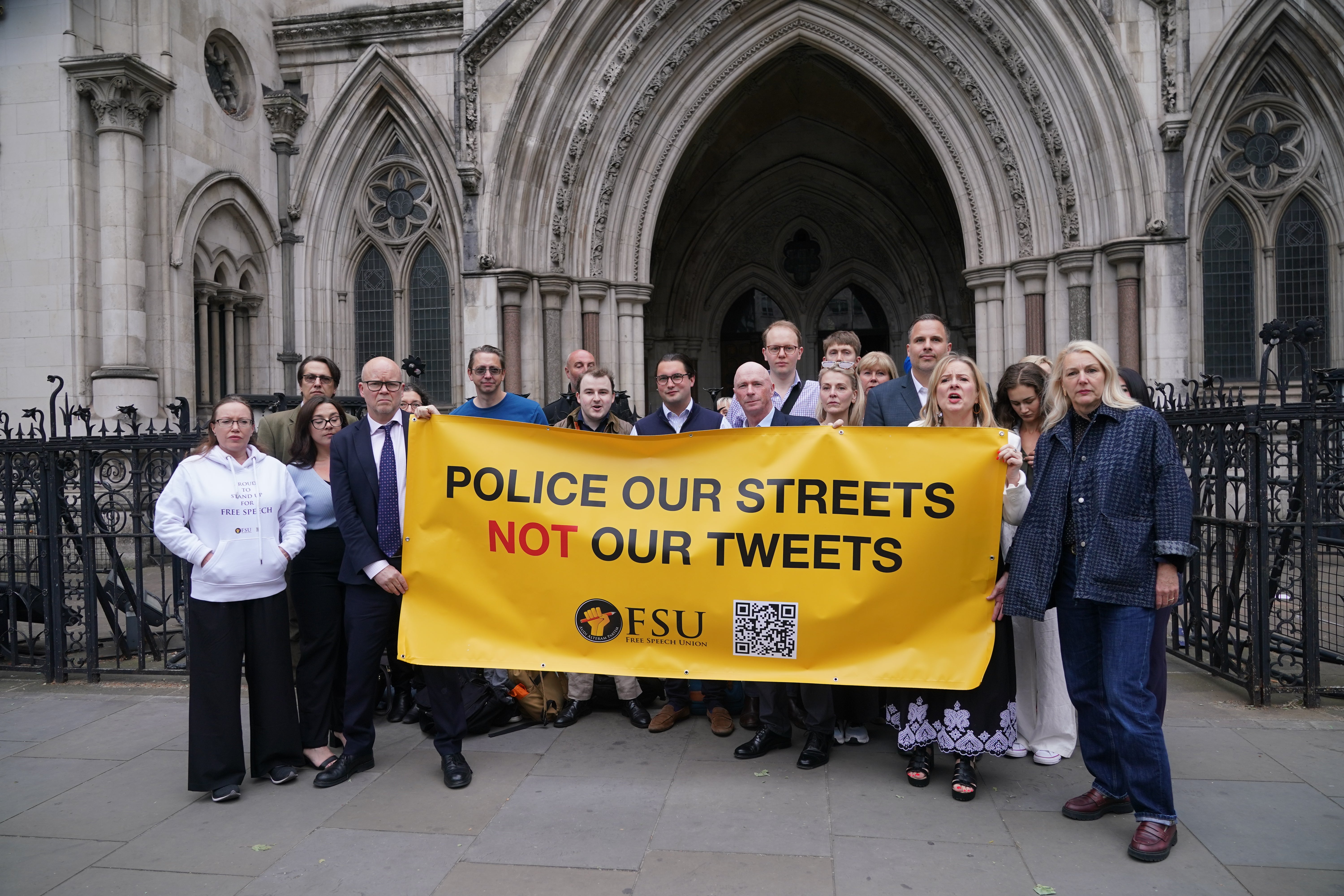 Former Conservative councillor Raymond Connolly (centre) with supporters include broadcaster Dan Wootton outside the Court of Appeal