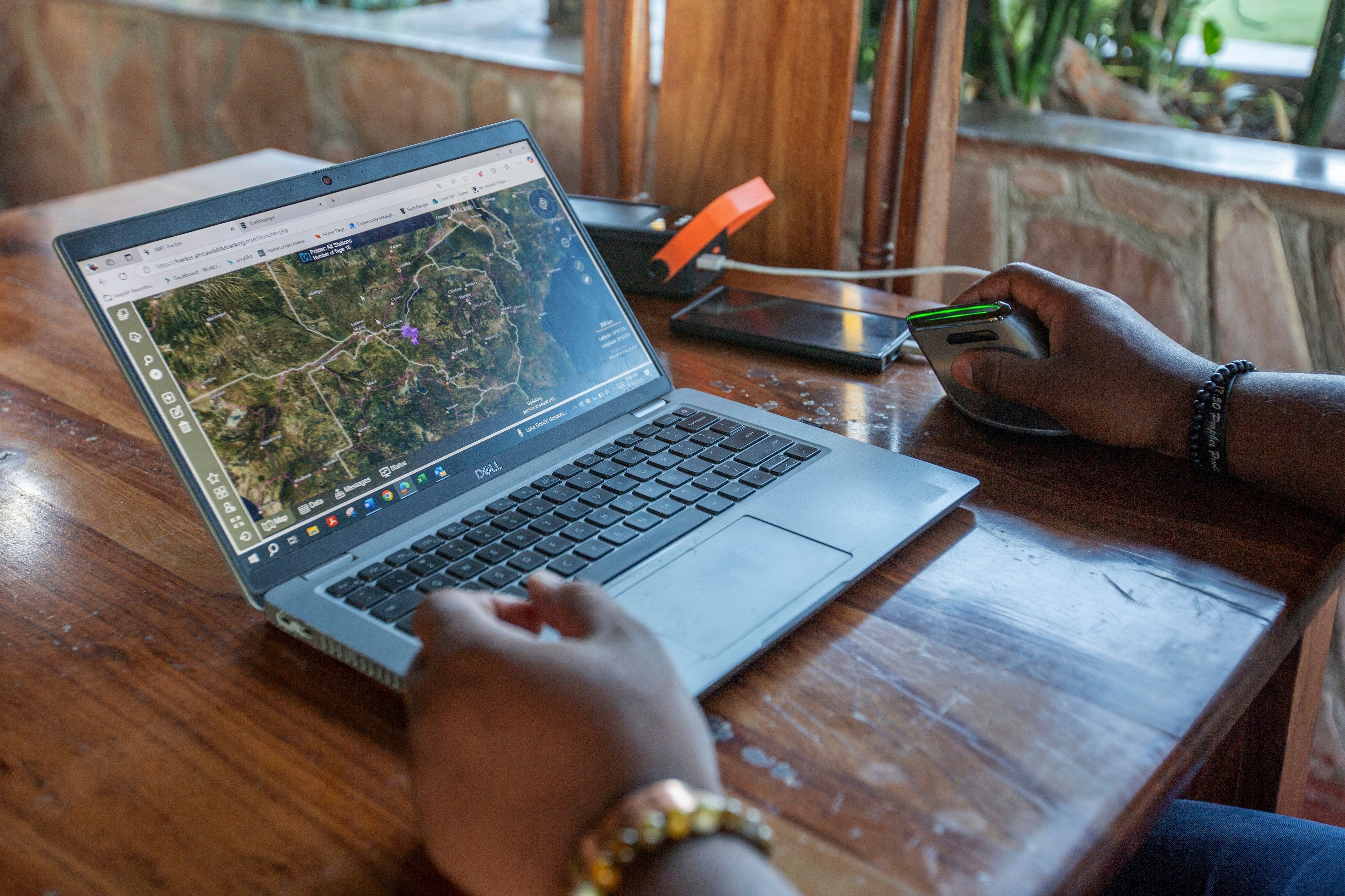 An official shows how the EarthRanger platform operates at Hwange National Park, Zimbabwe, Wednesday, April 30, 2025. (AP Photo/Aaron Ufumeli)