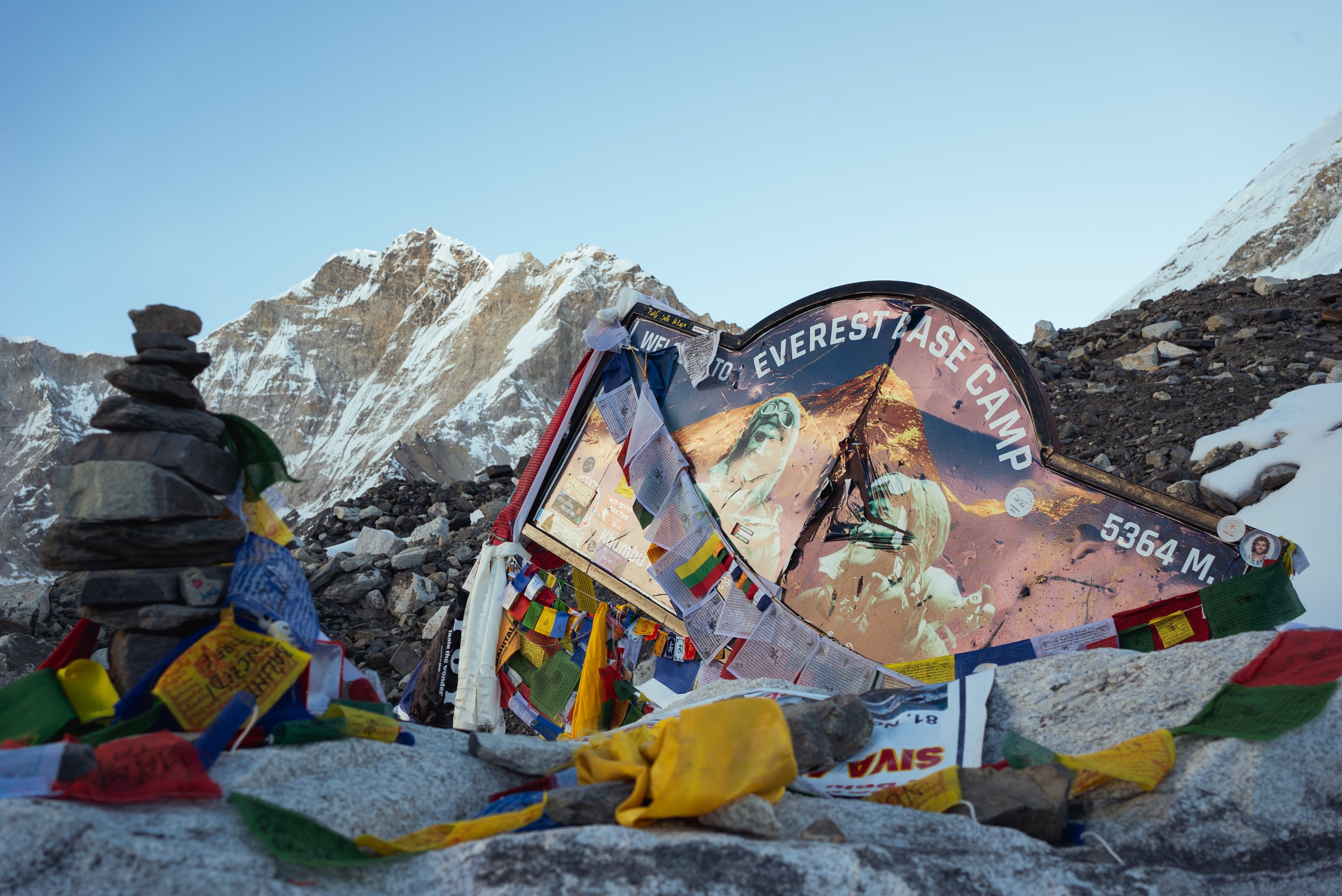 File. A damaged sign and prayer flags mark the entrance to Everest Base Camp in Nepal