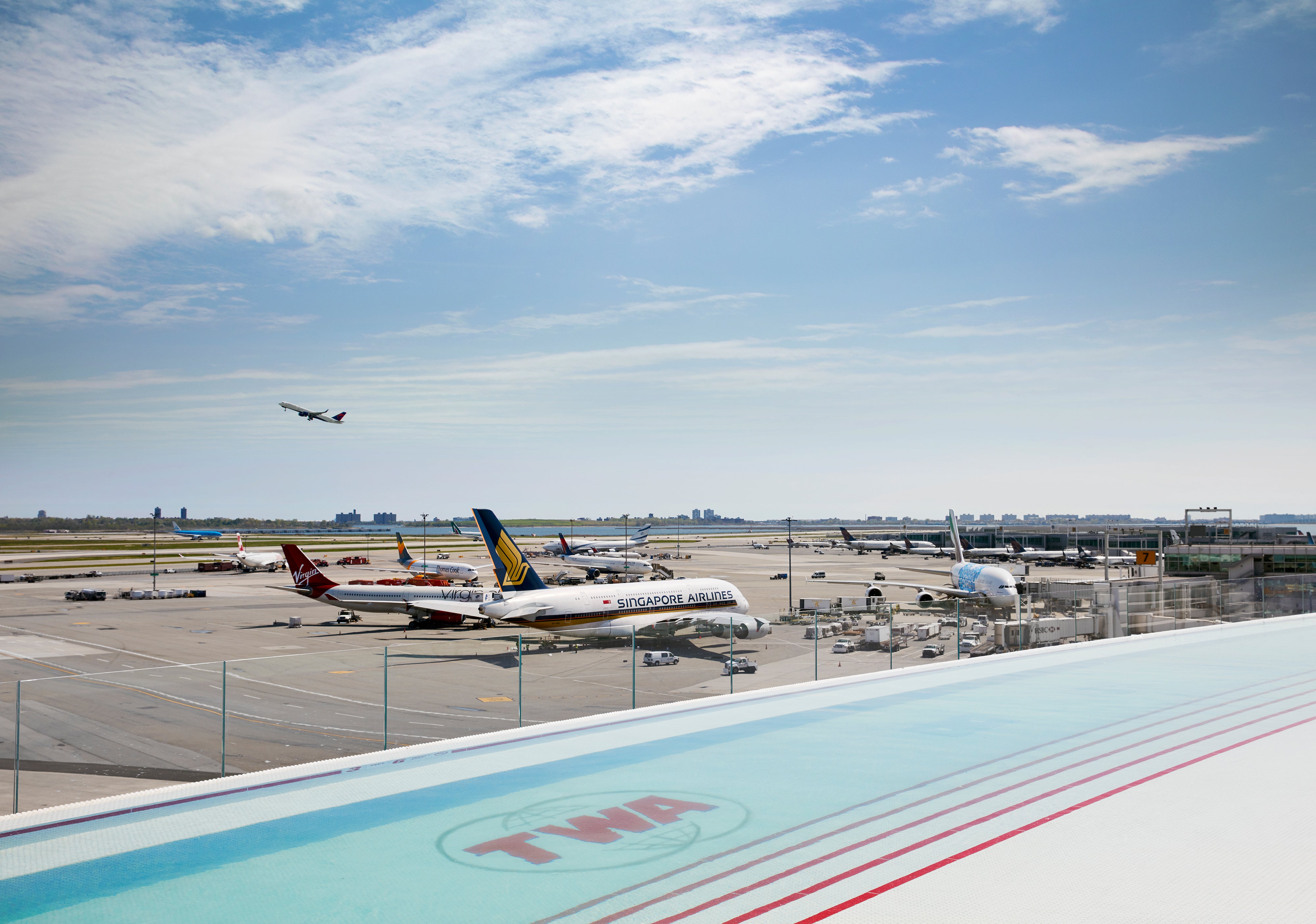 Plane amazing: The TWA Hotel pool offers views of JFK's Runway 4 Left/22 Right and taxiing aircraft
