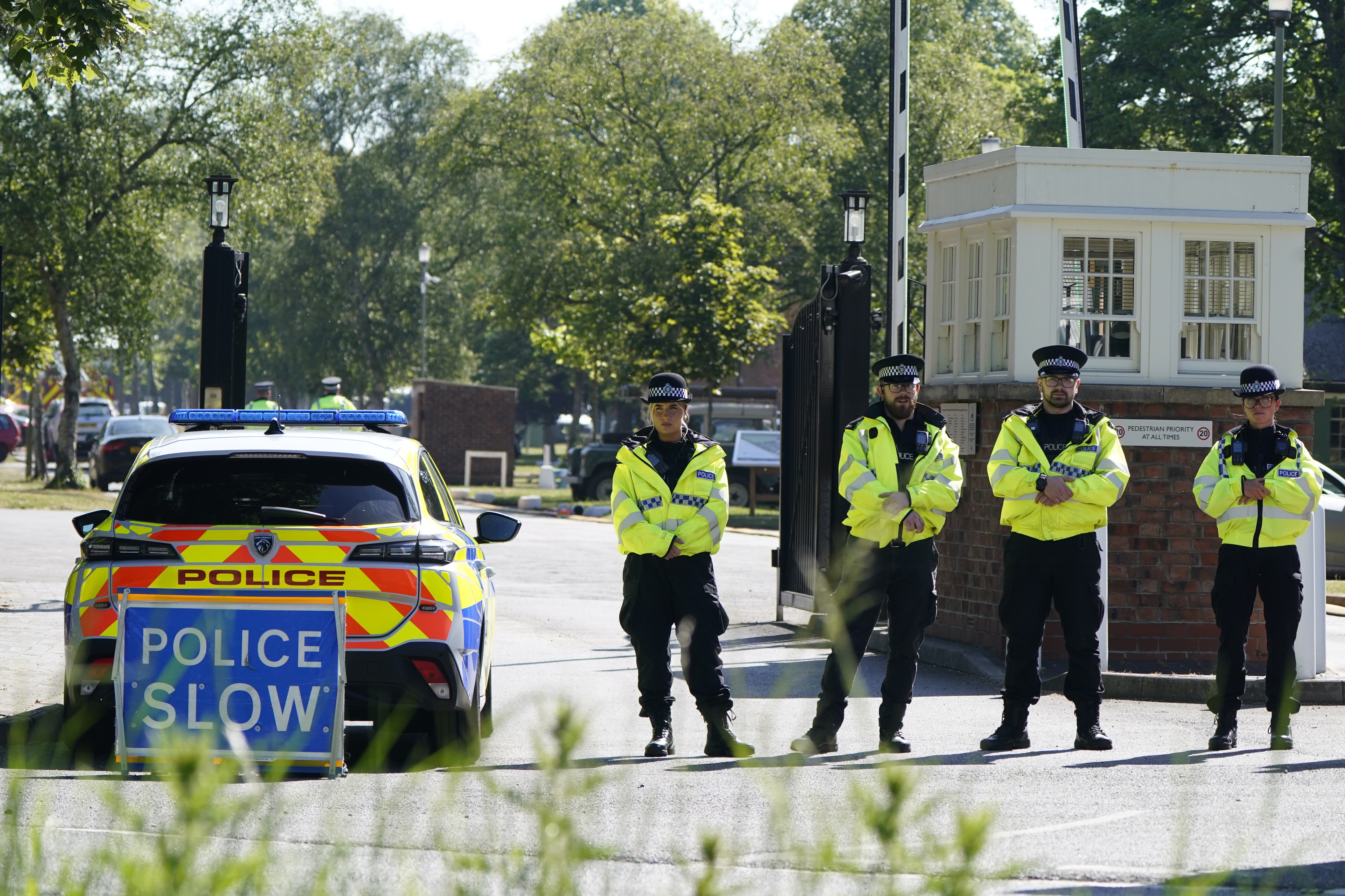 Police officers patrol at a cordon near the scene of a fire at Bicester Motion in Oxfordshire