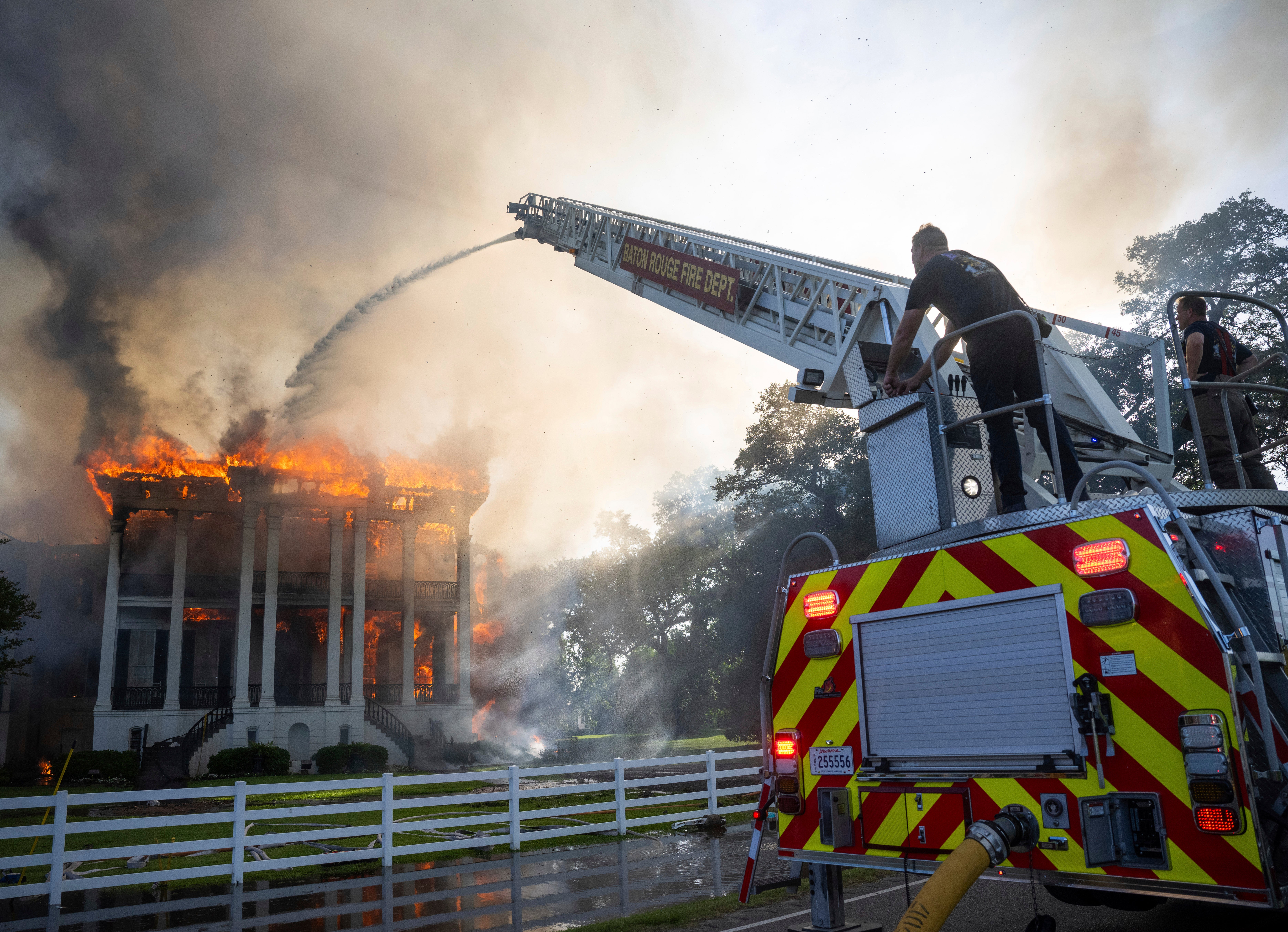 Firefighters try to extinguish the flames engulfing the Nottoway Plantation.